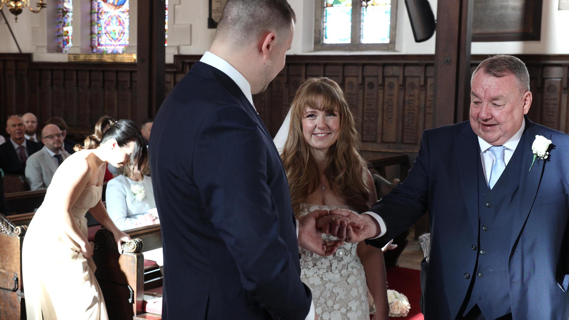dad gives his daughters hand in marriage during ceremony