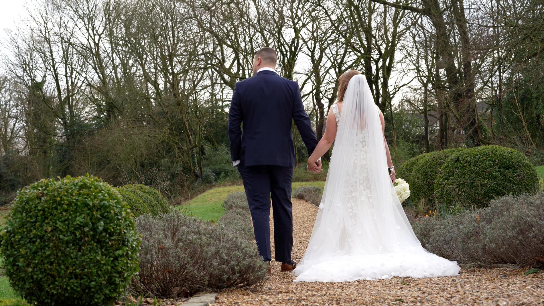 a video still of a couple walking around the gardens at Ashfield House Standish