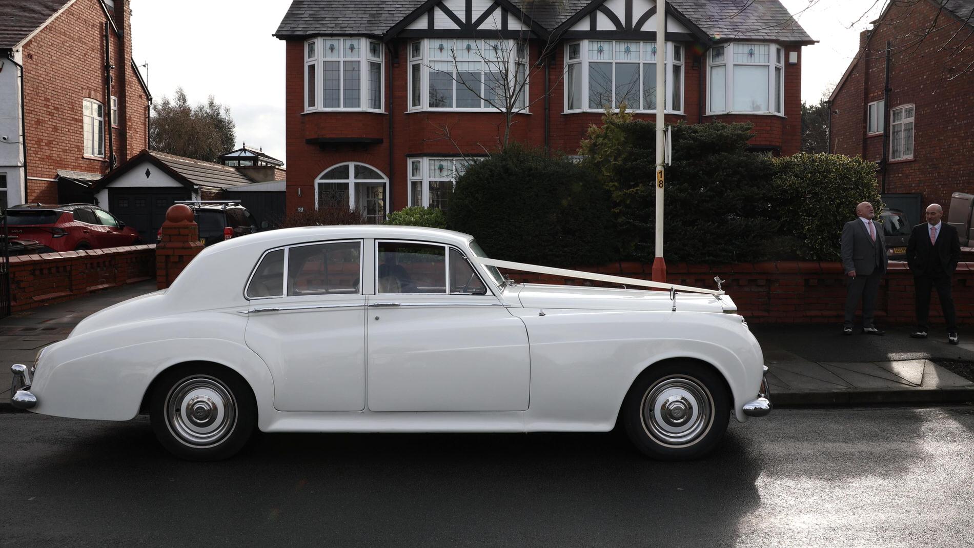 a classic rolls royce by magnolia classics waits outside in Churchtown