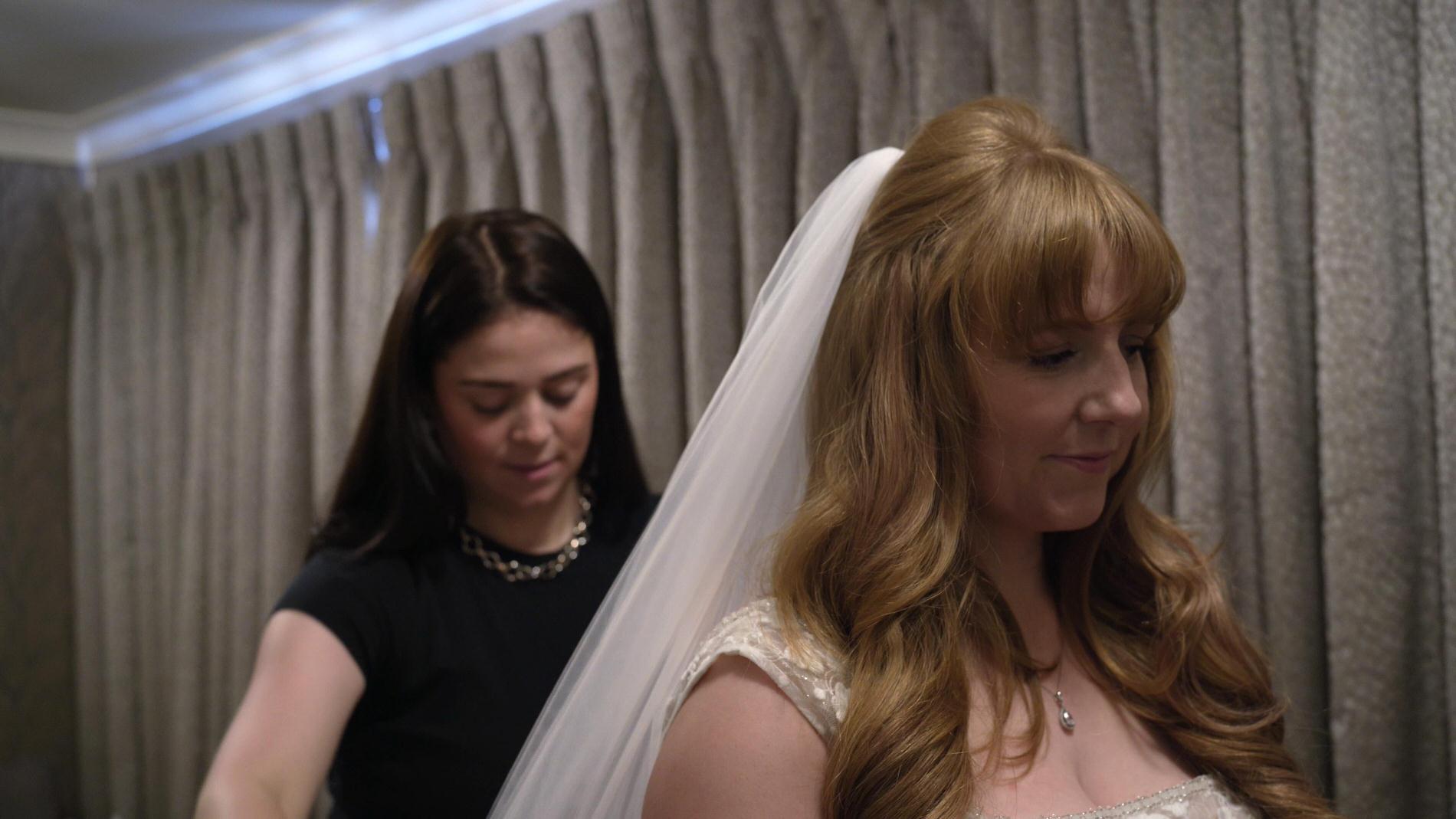 Sophie from SJ faces puts the brides veil on