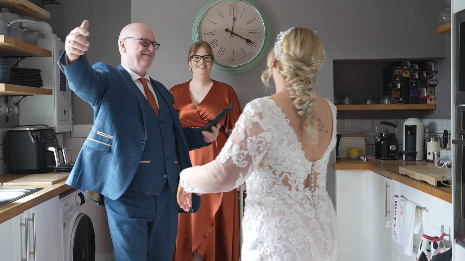 dad goes to hug the bride