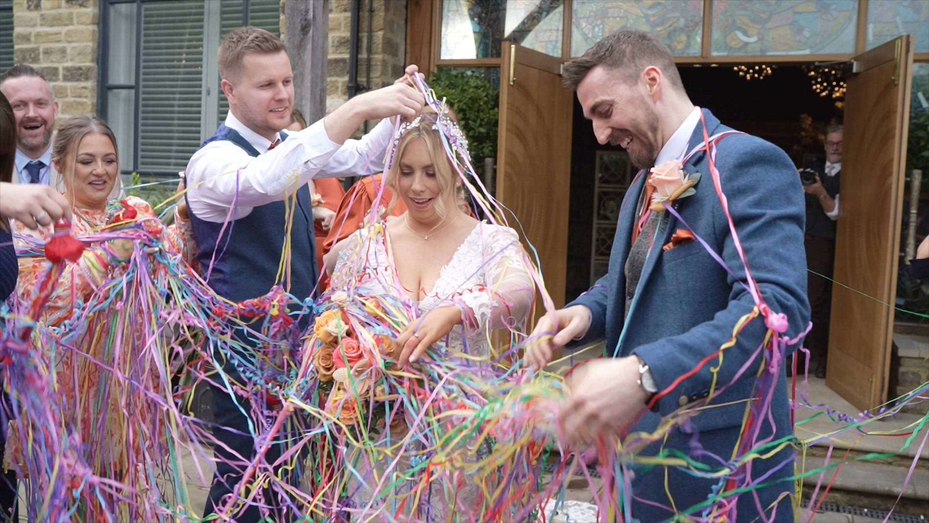 guests help the couple get untangled from the confetti streamers Manor House Lindley