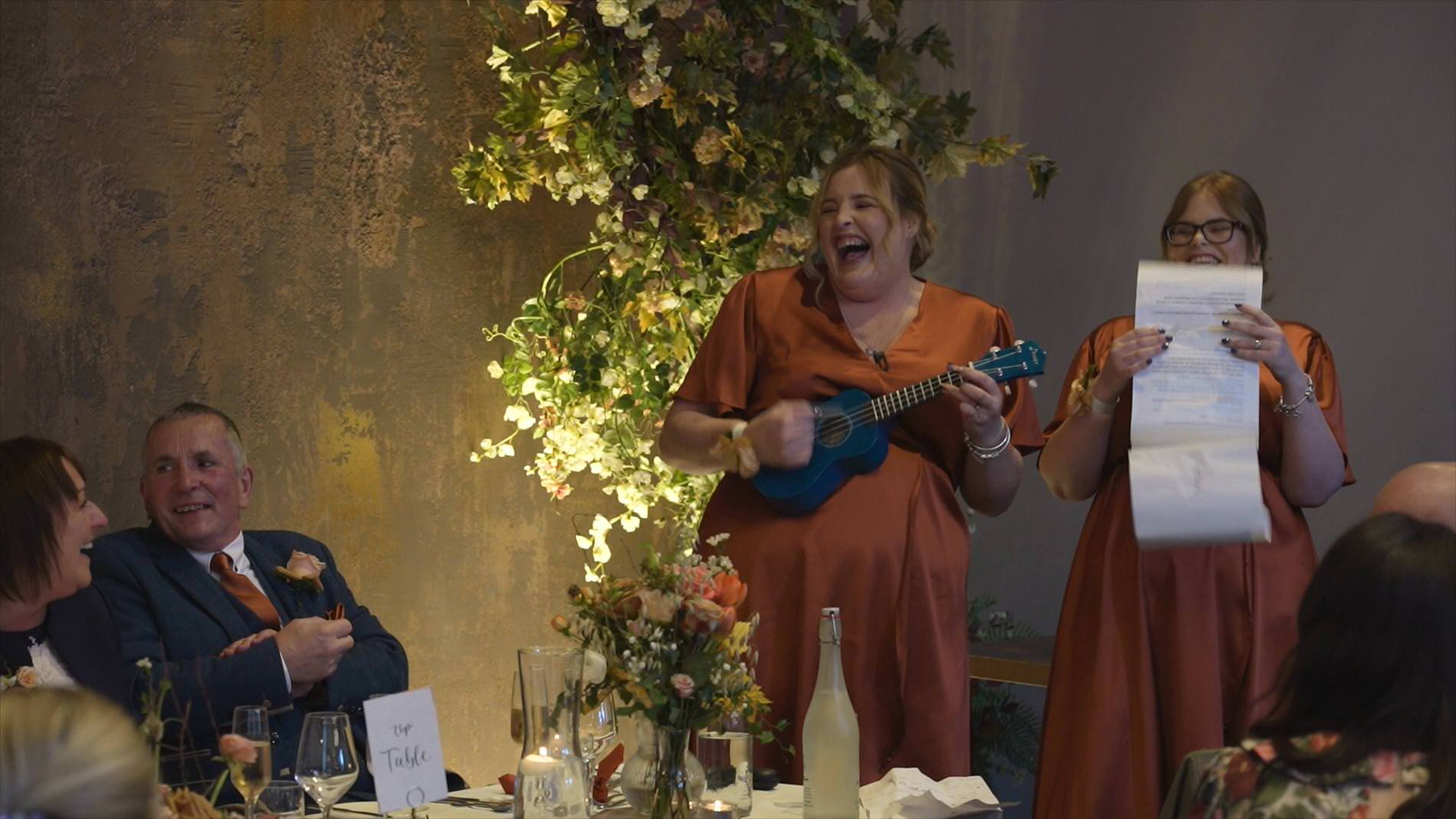 the bridesmaids perform a fun ukulele speech during Manor House Lindley wedding