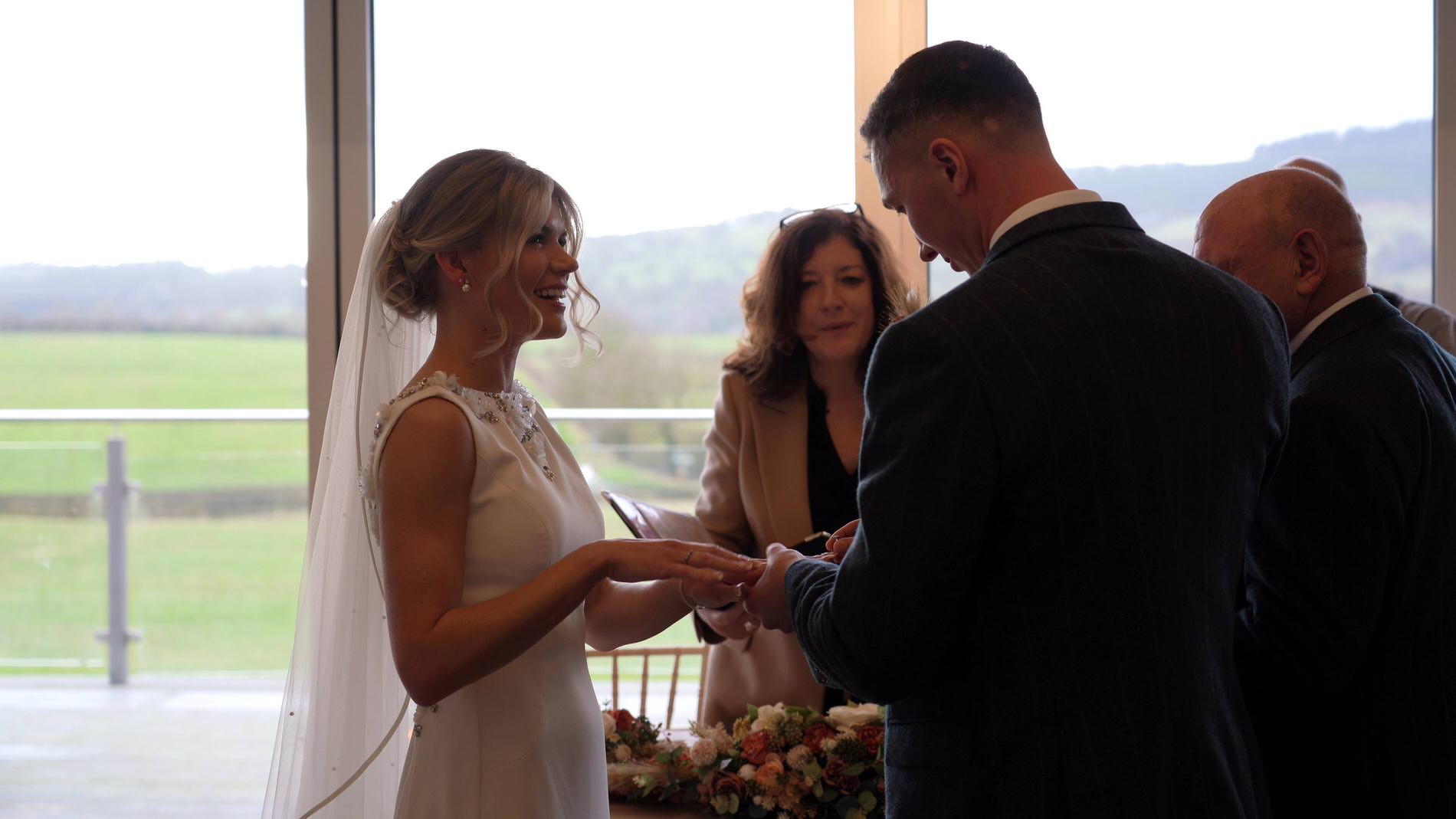 grandad watches over the couple exchanging wedding rings