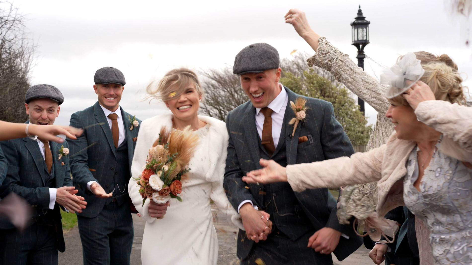 a very windy confetti walk outside Bashall Barn Lancashire