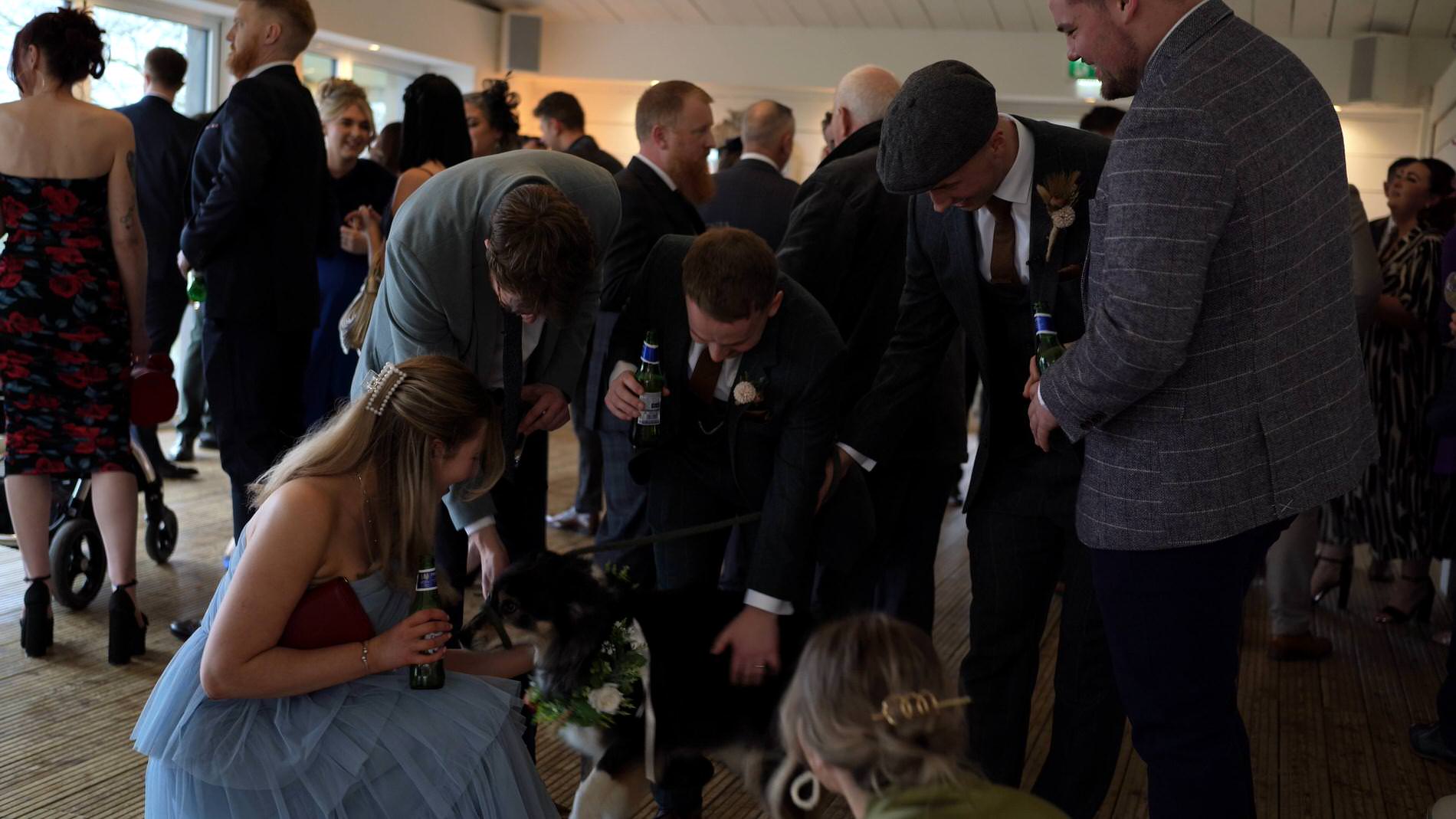 guests fuss their dog who visits them after the ceremony at Bashall