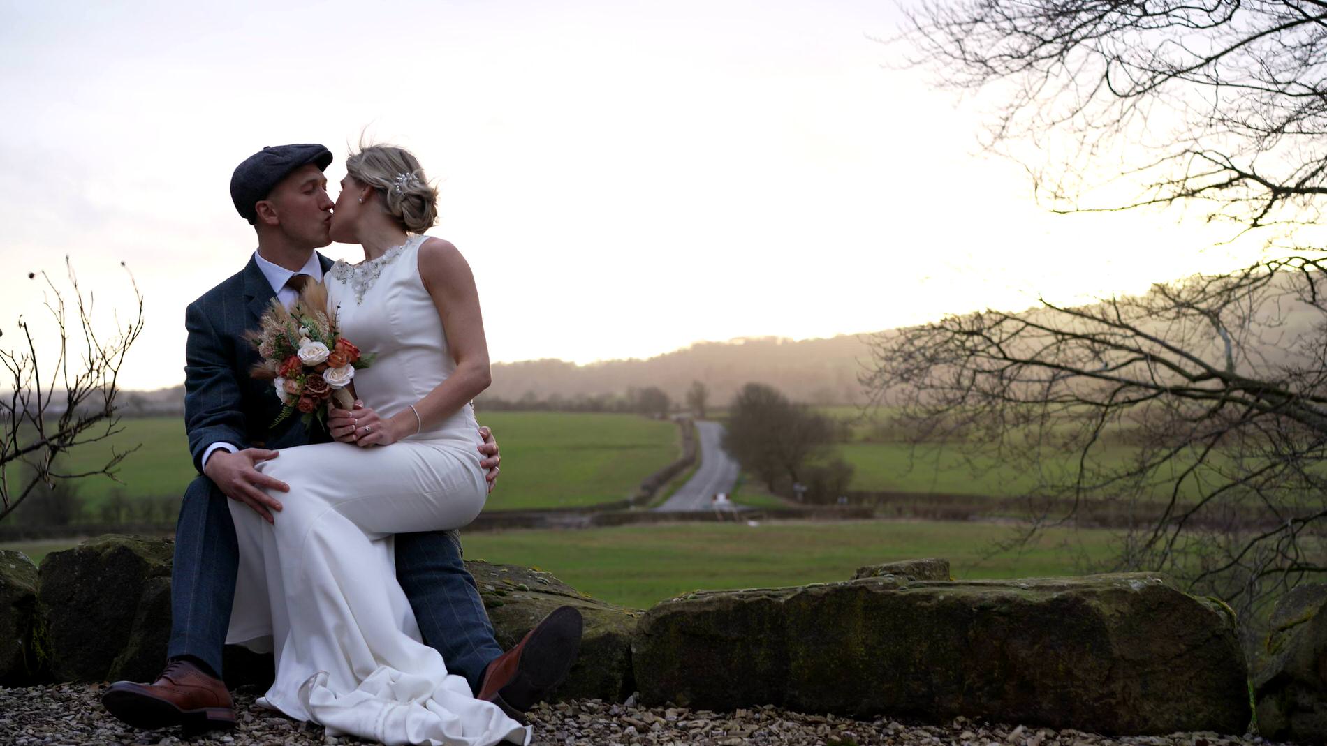 a dramatic storm couples portrait with the winter sun at Bashall Barn