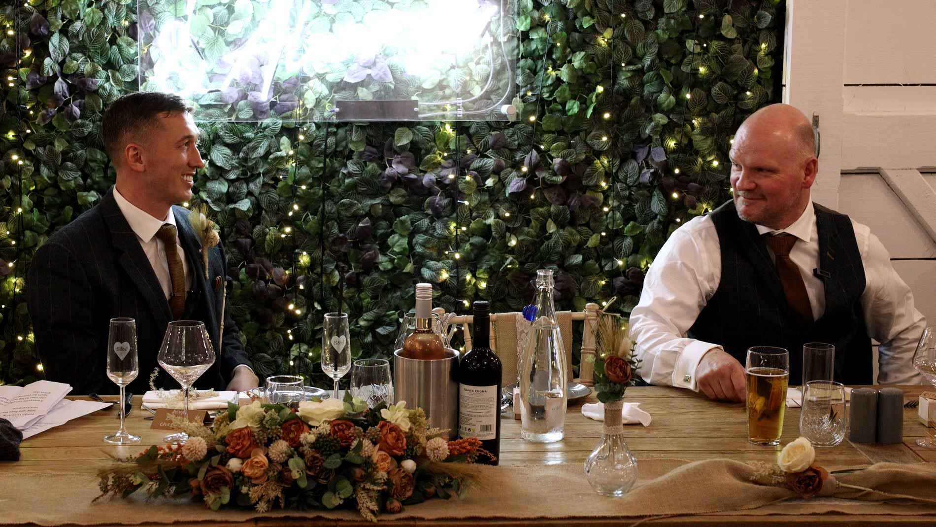 the father of the bride glances at groom during the brides singing surprise