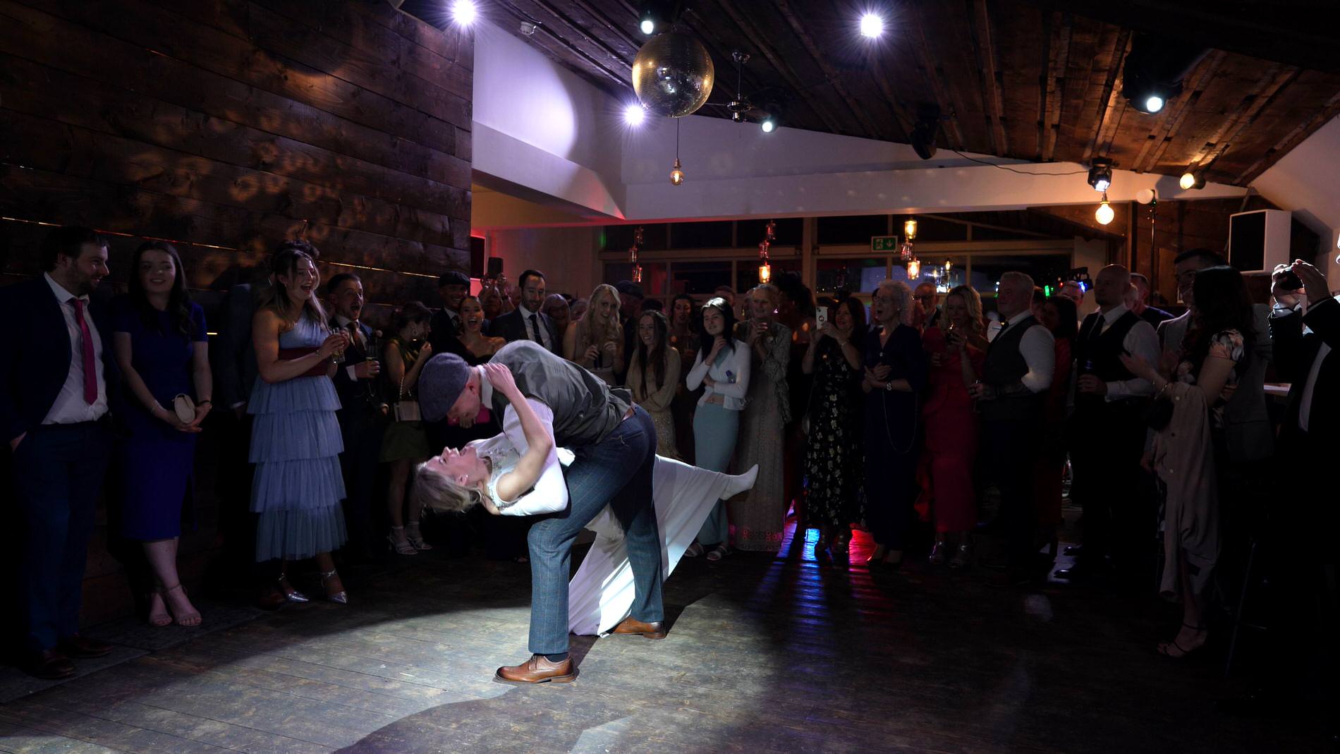 the crowd cheer as the couple enjoy their first dance at Bashall Barn