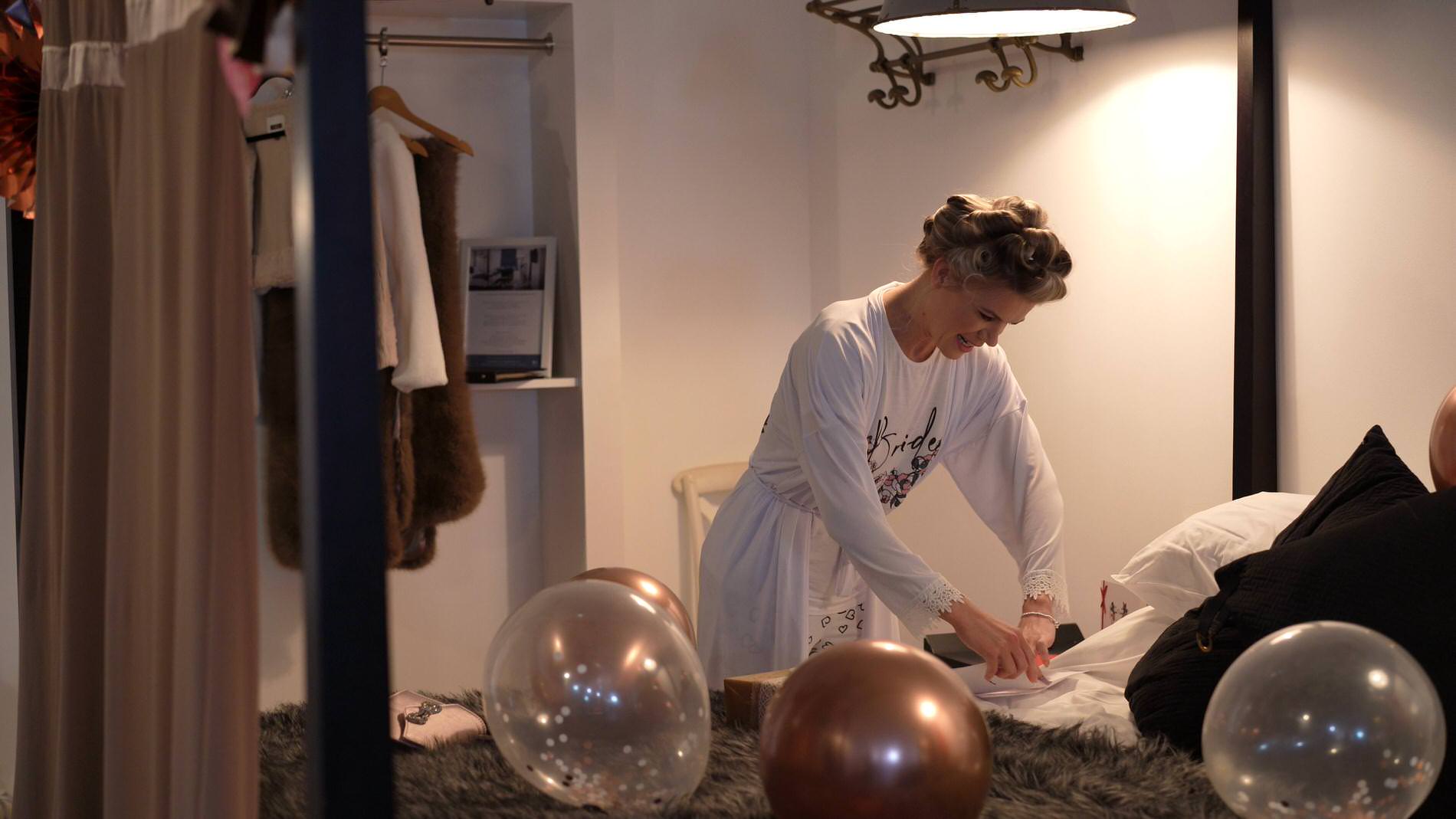 a bride giggles as she writes her Grooms wedding card