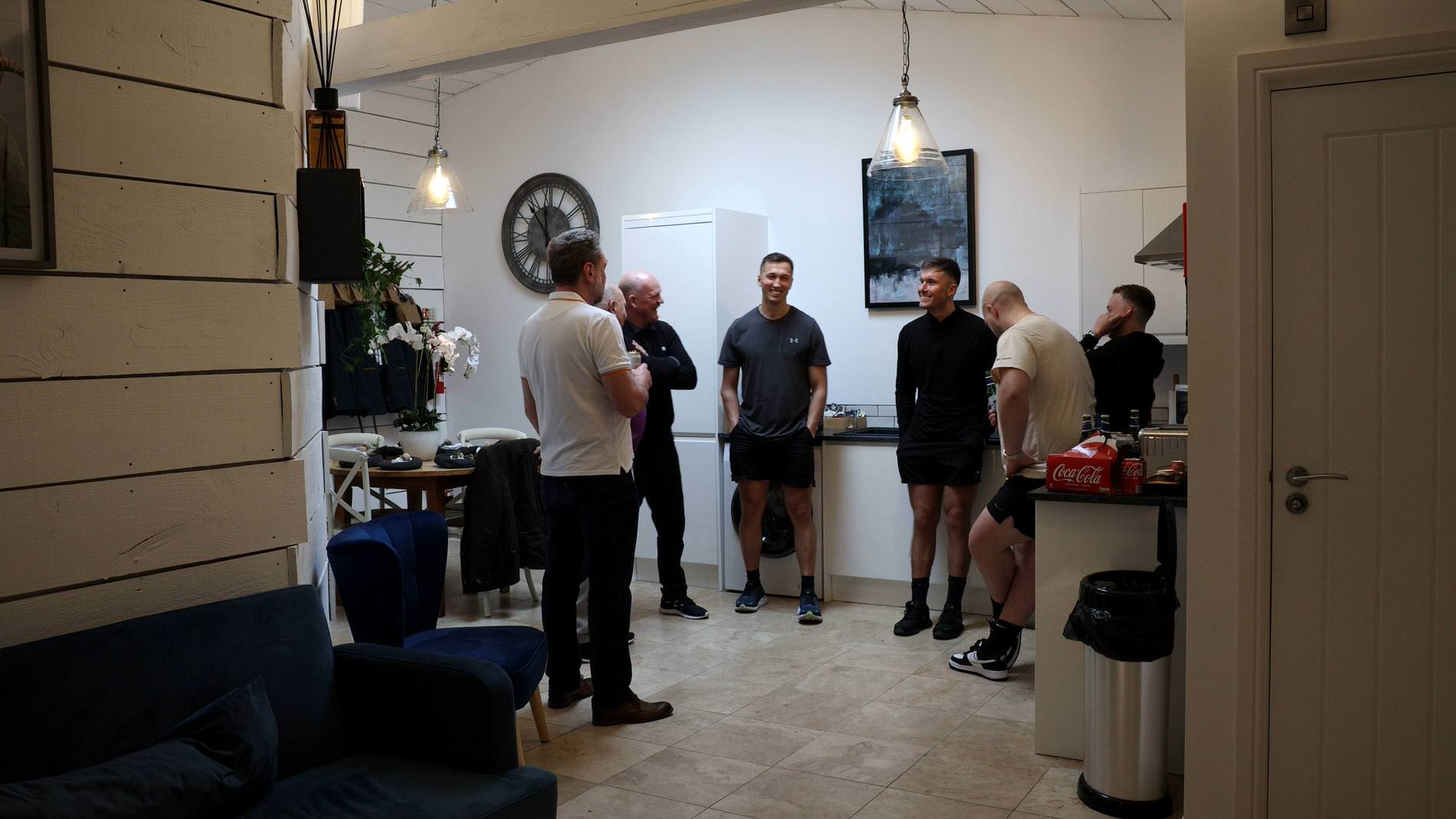 groomsmen laugh and drink getting ready at Bashall Barn