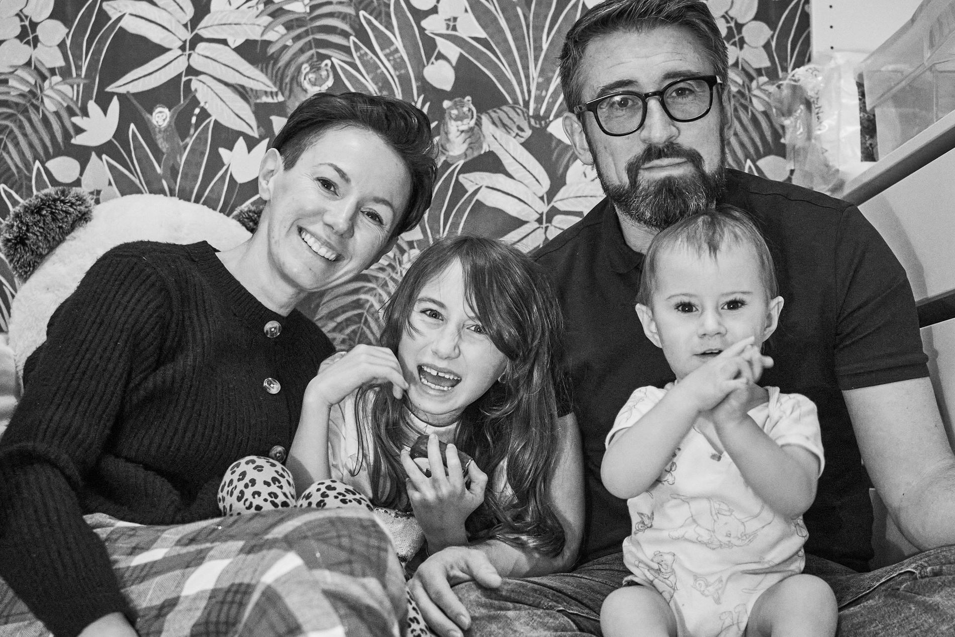 self timer posed photo of a family at home