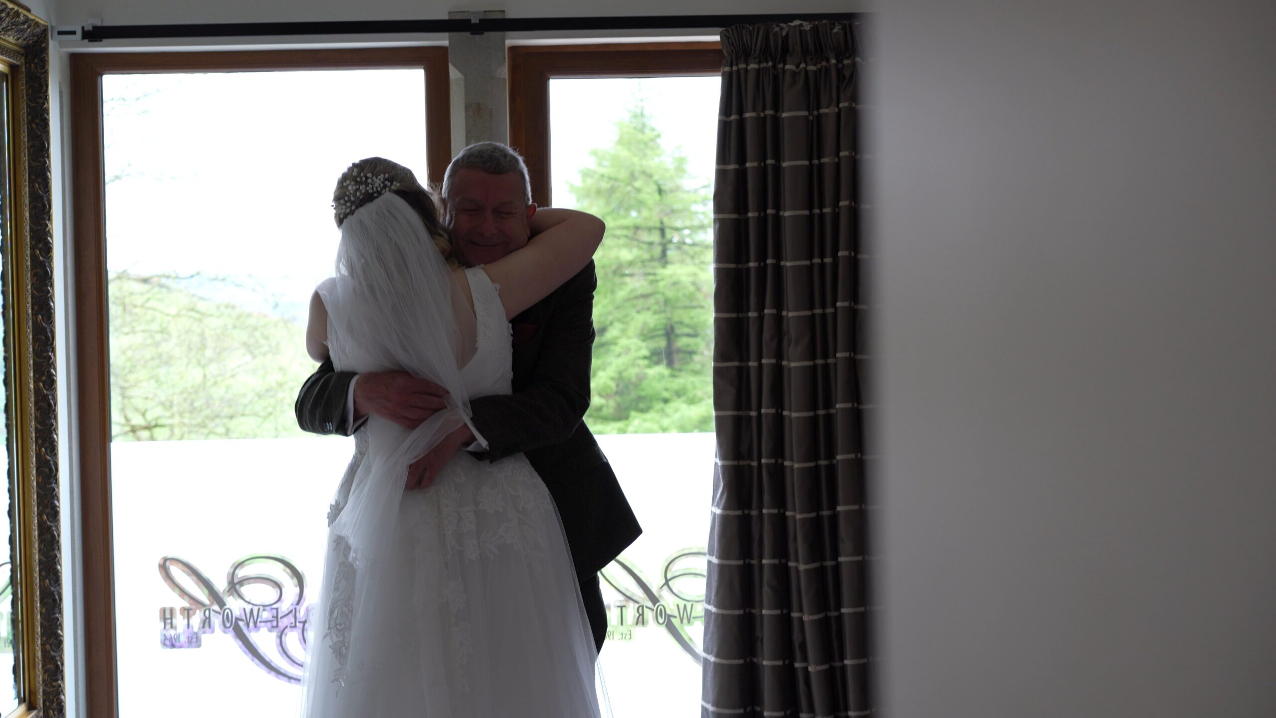 the brides dad gives her a big hug before she goes to get married at The Saddleworth Hotel