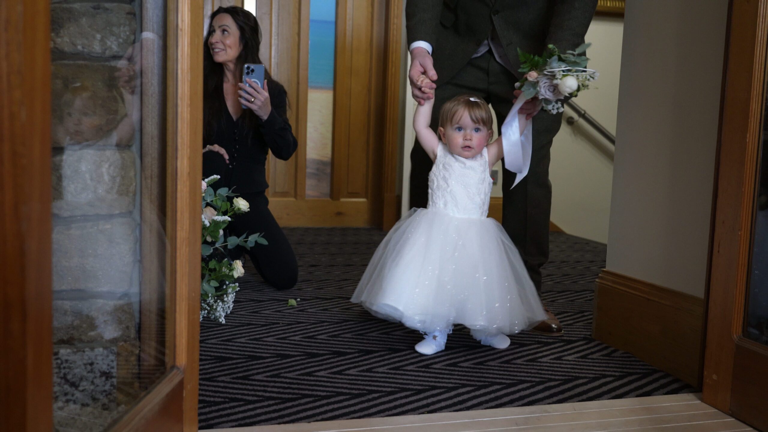 a little flower girl tries to walk down the aisle at The Saddleworth Hotel