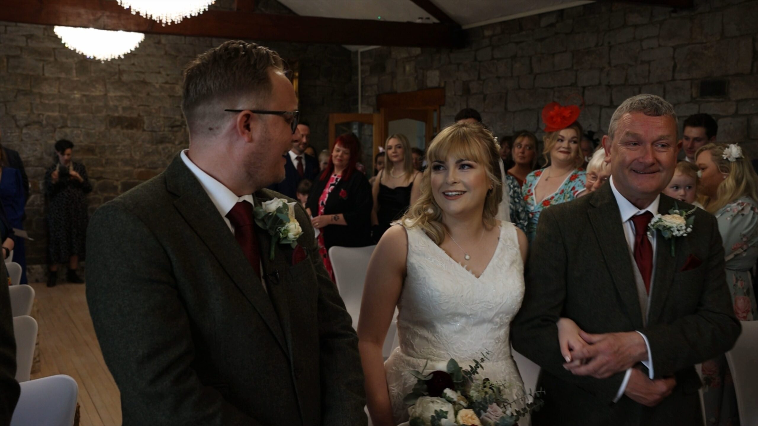 the couple smile at each other at the start of the indoor ceremony at The Saddleworth Hotel