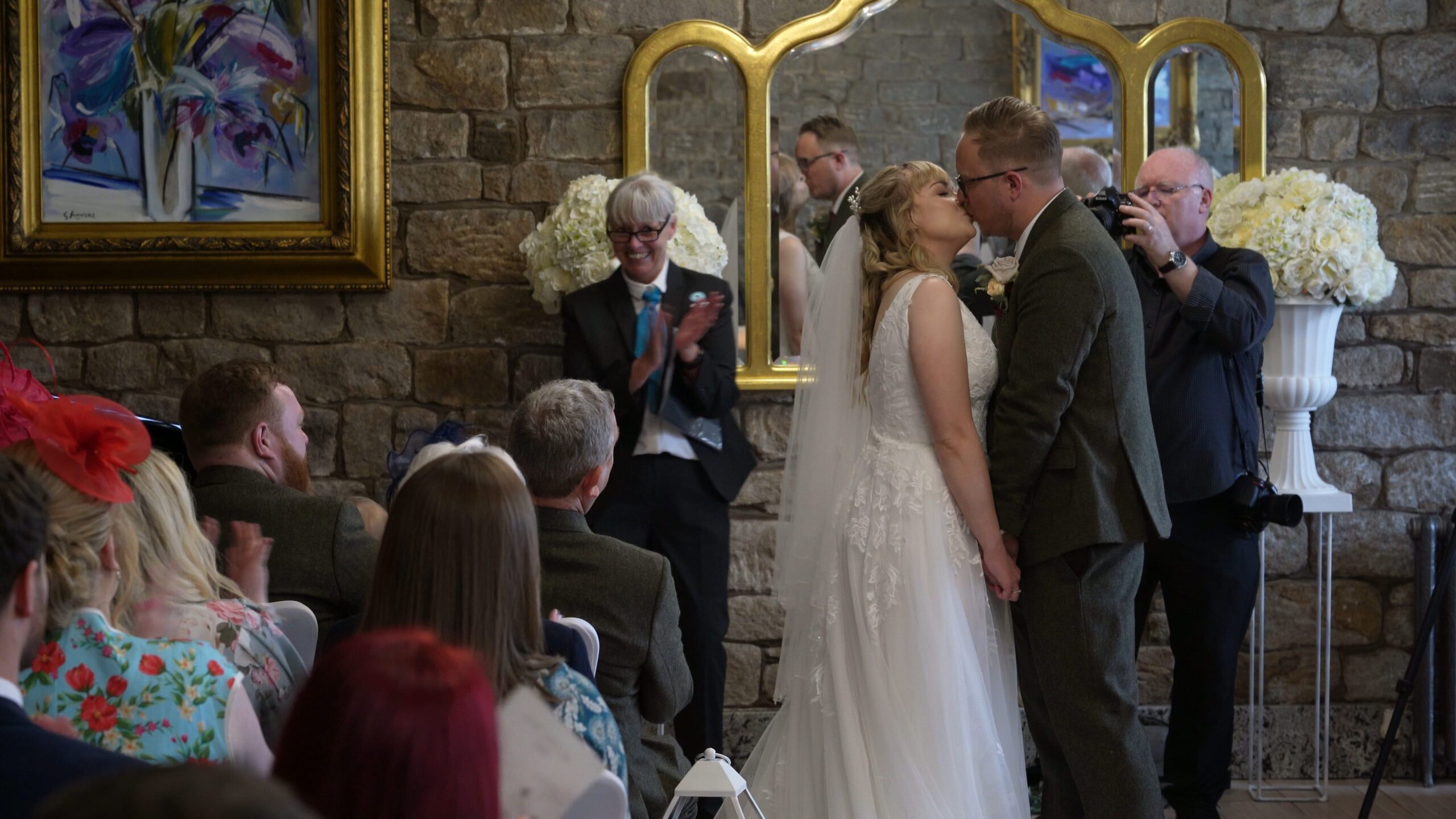 the couple kiss during the wedding ceremony at The Saddleworth Hotel
