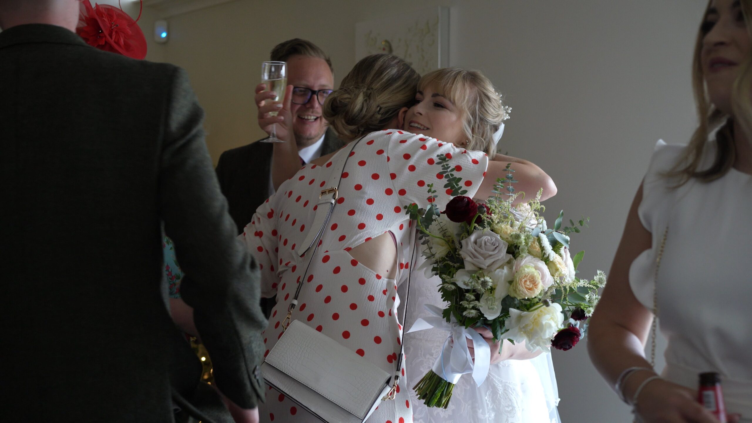 a guest hugs the bride at The Saddleworth Hotel