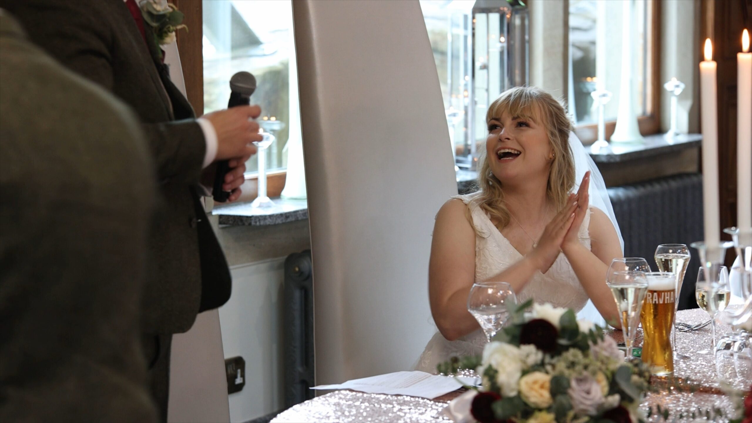 the bride laughs at her groom during his wedding speech at The Saddleworth Hotel