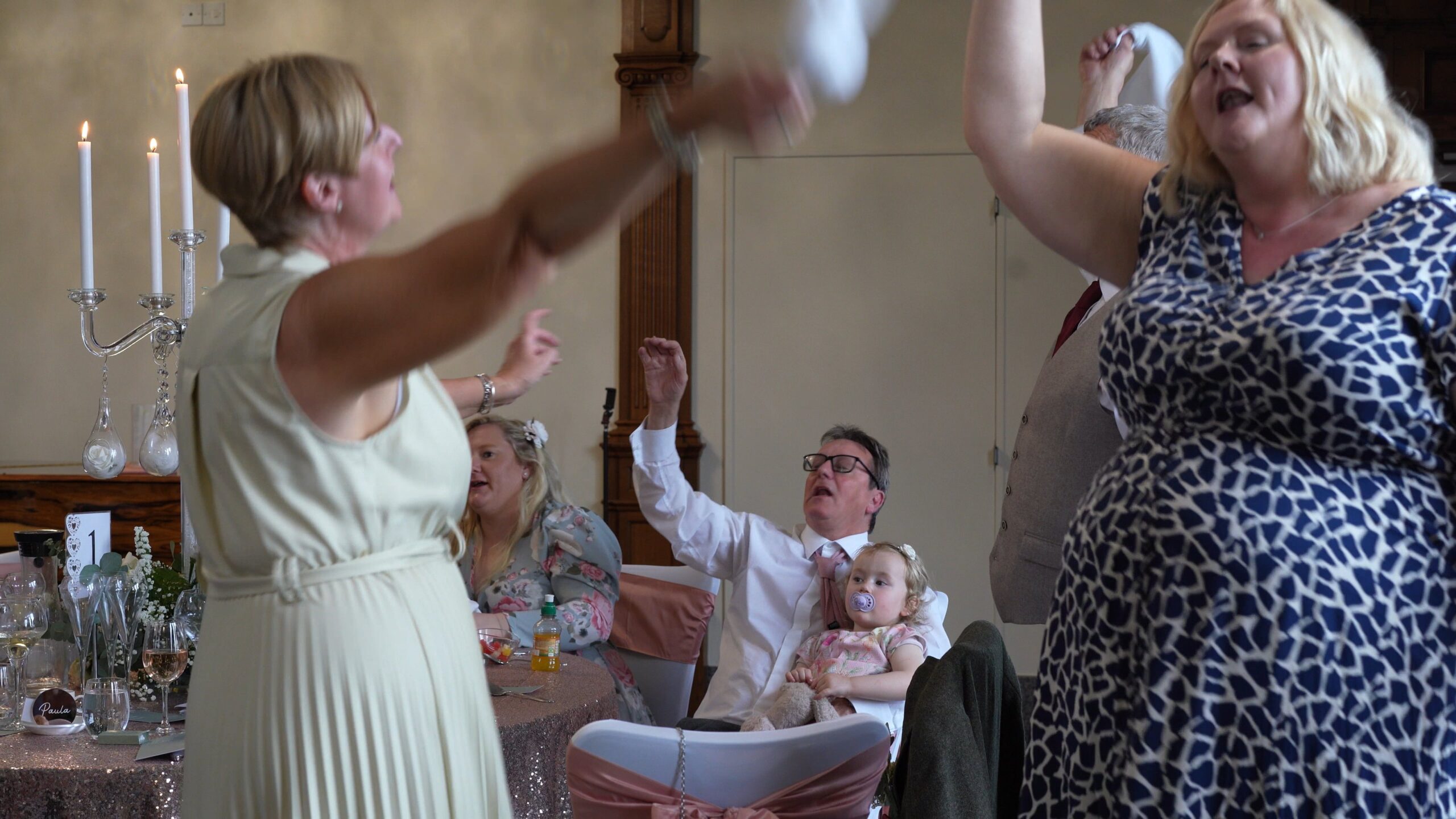 guests dance and wave napkins during surprise singing waiters
