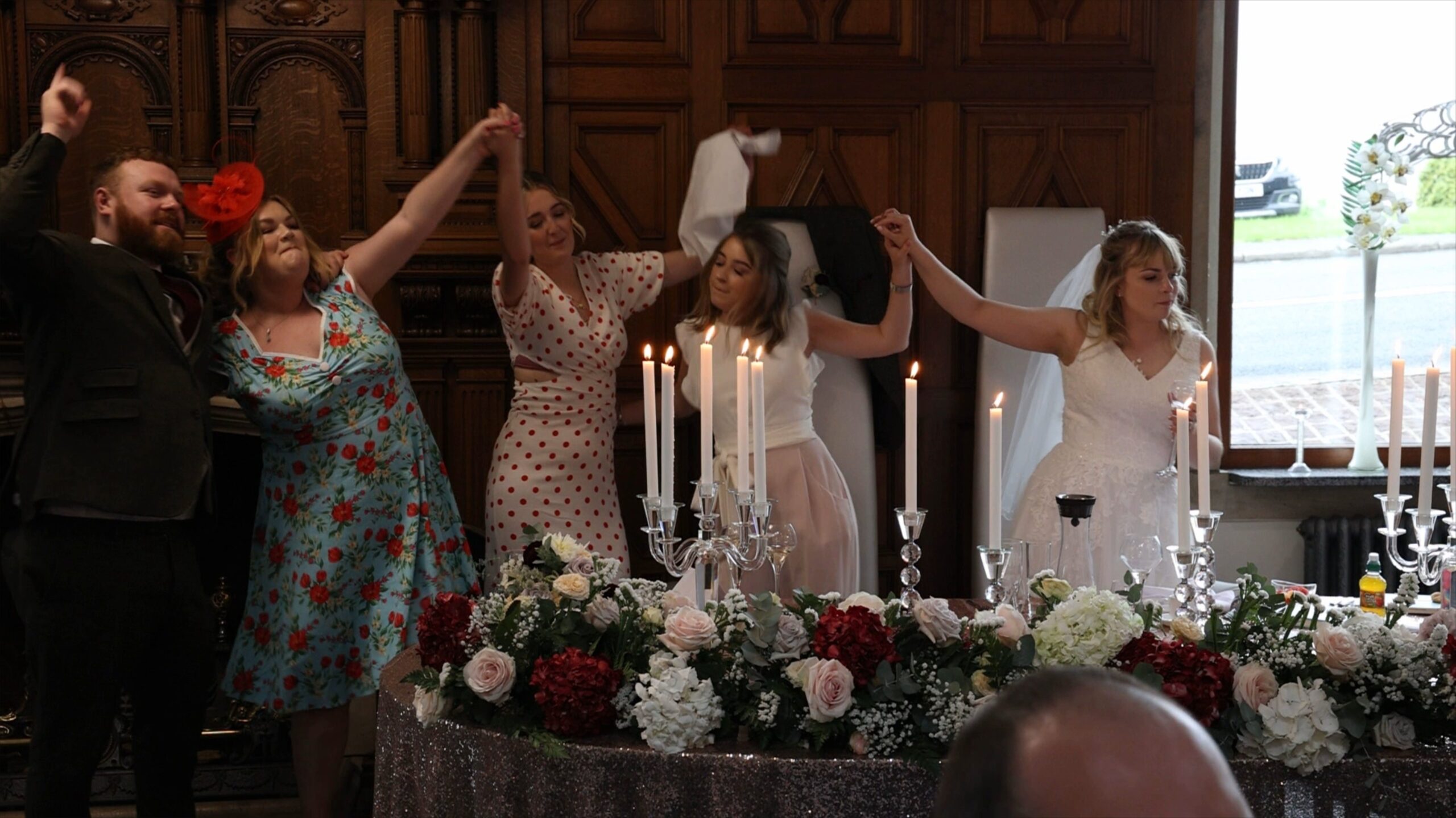 friends dance and sing along with the couple during surprise singing waiters