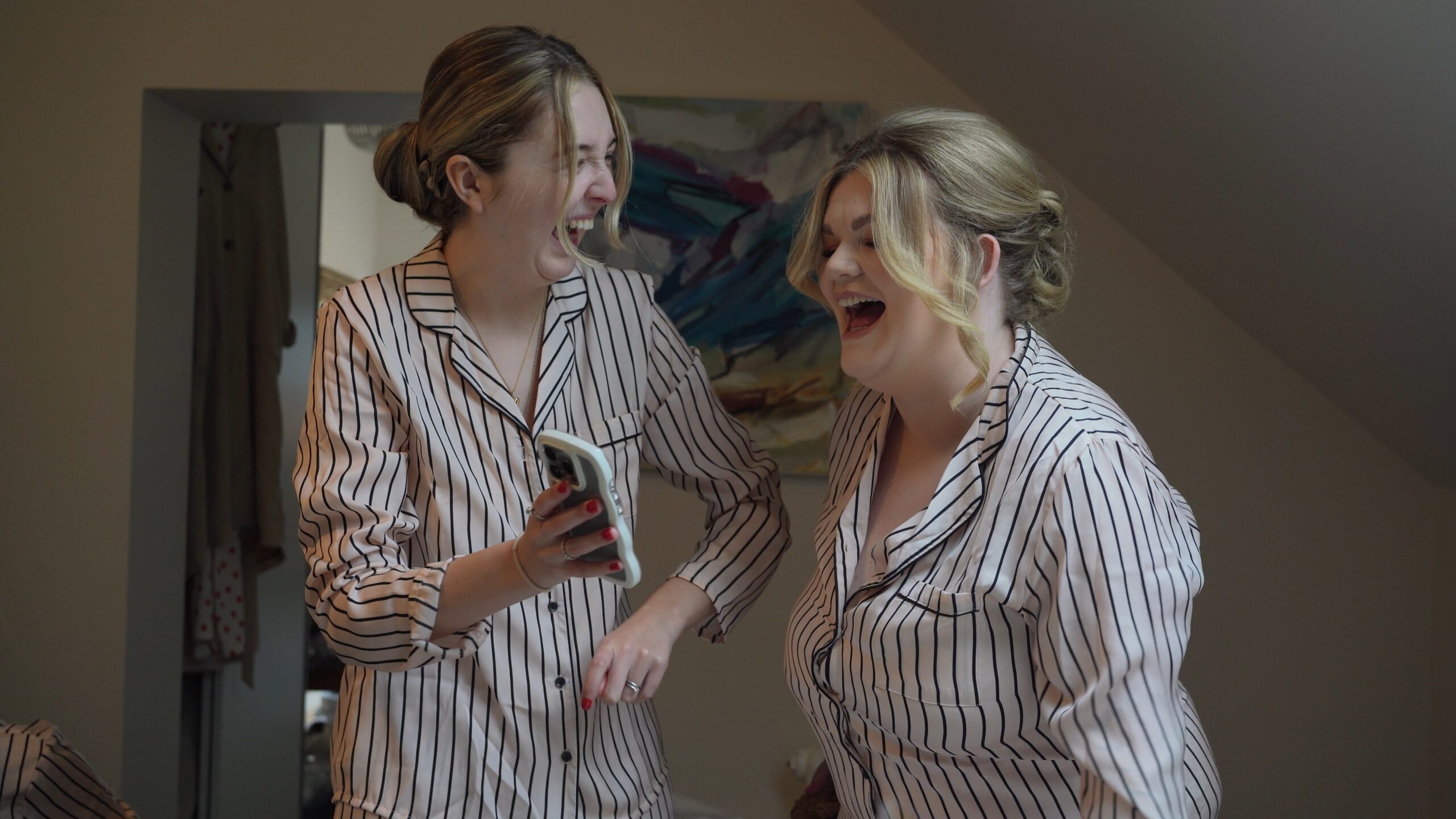 a candid moment between two friends laughing filmed by the wedding videographer at Saddleworth Hotel