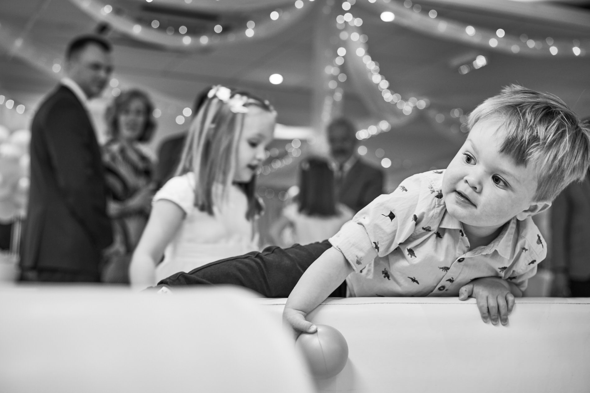 a little boy clambers over a softplay