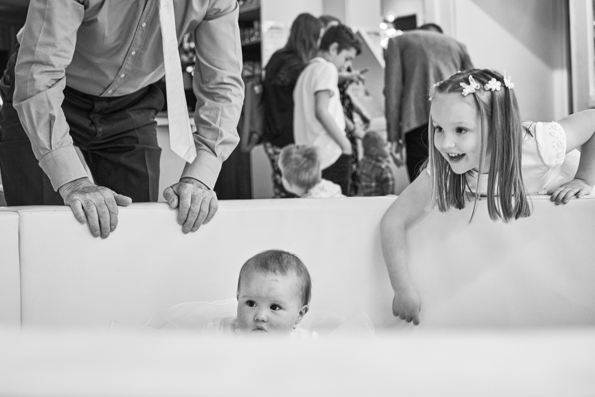 a baby plays in the soft play with her sister