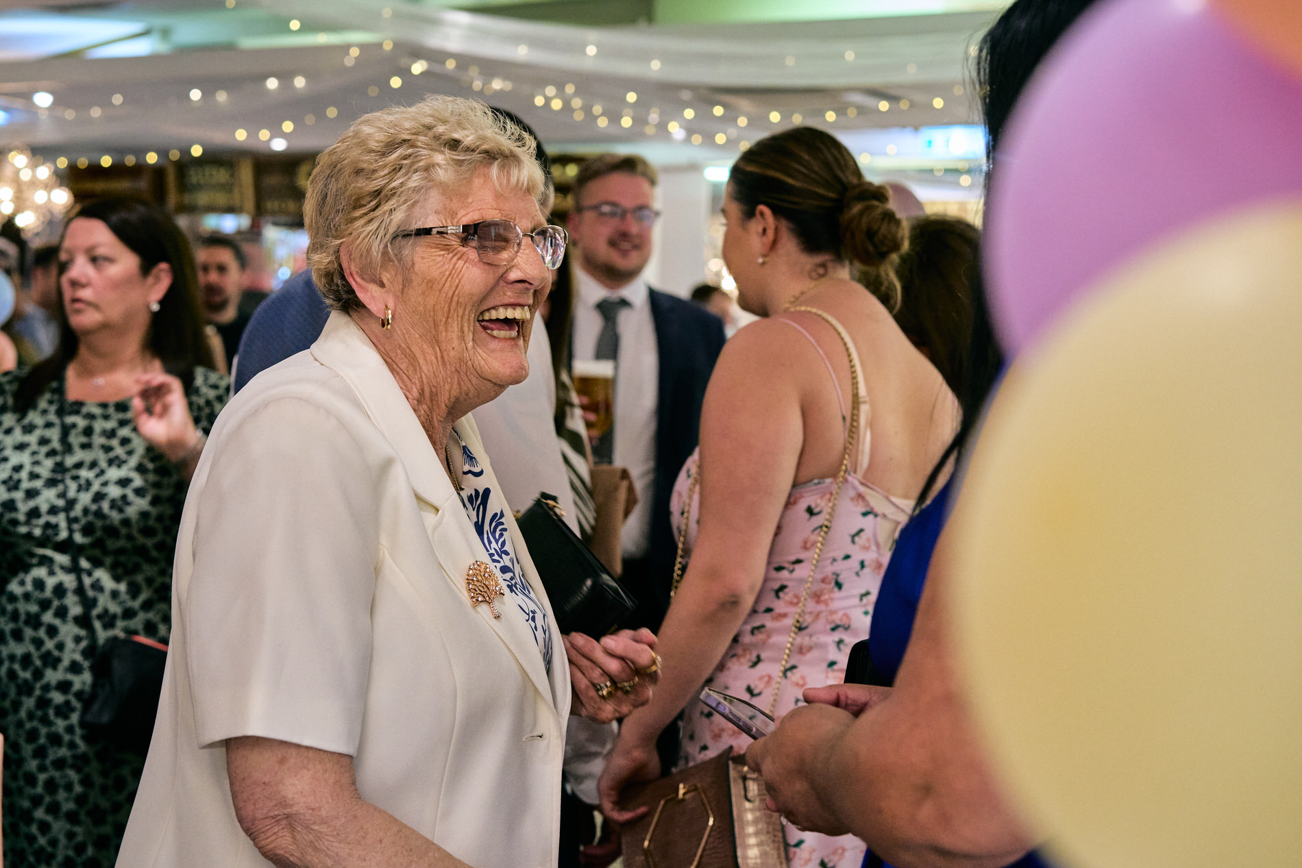 an old lady grandma laughs with other guests