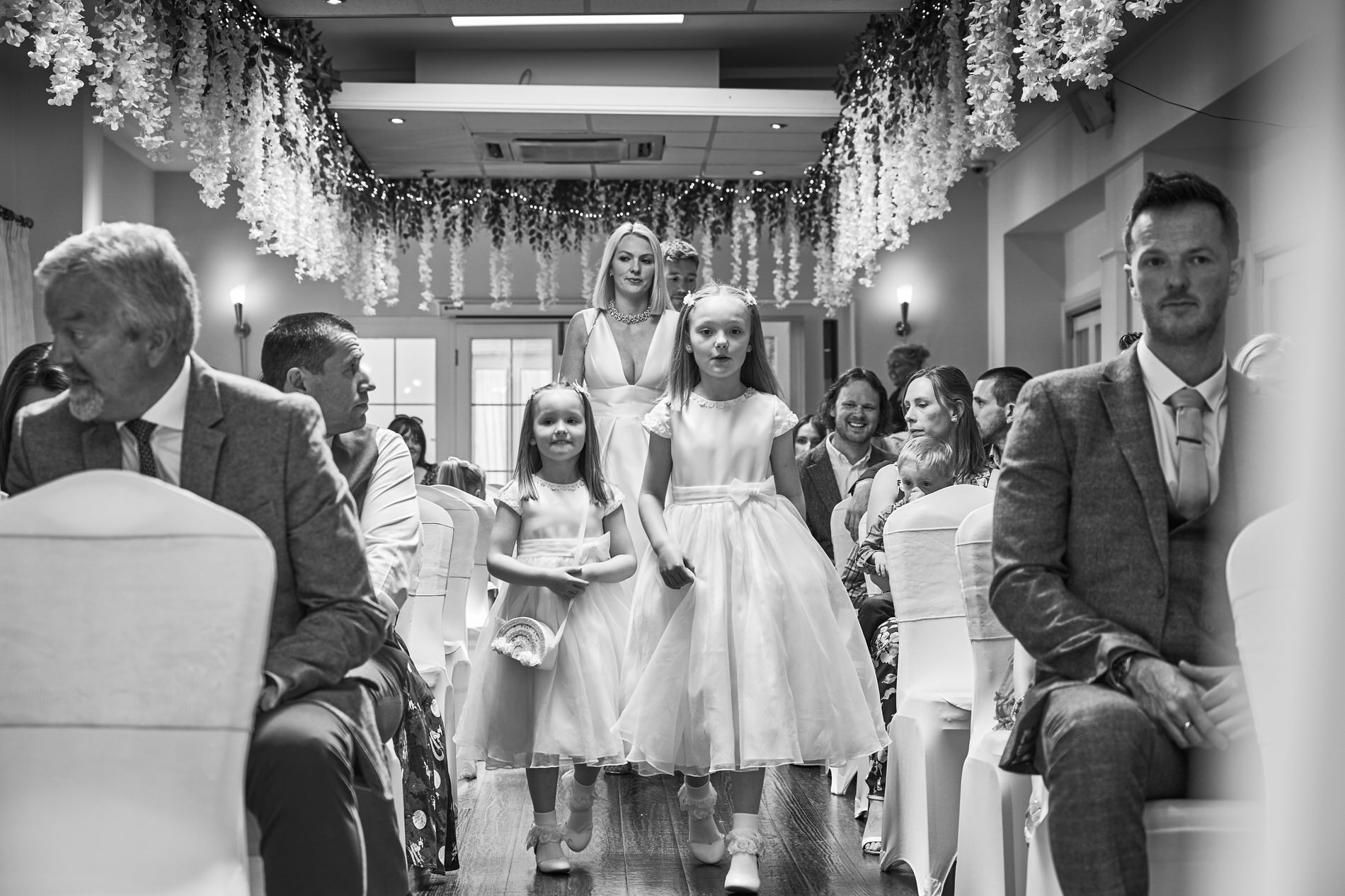 a family walk down the aisle for their naming ceremony at Holland Hall