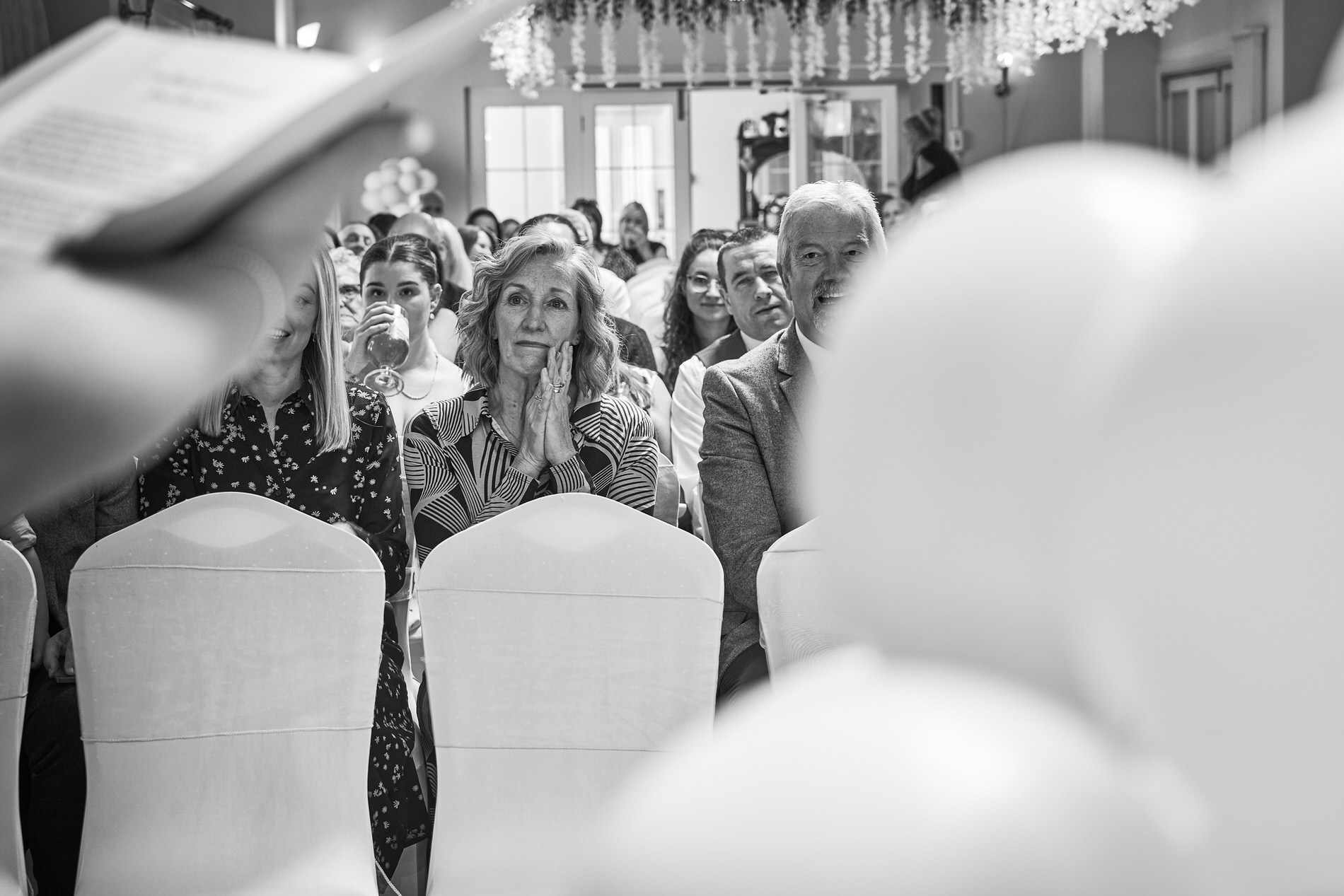 a guest looks proud and emotional in a candid photo during a celebrant led naming ceremony