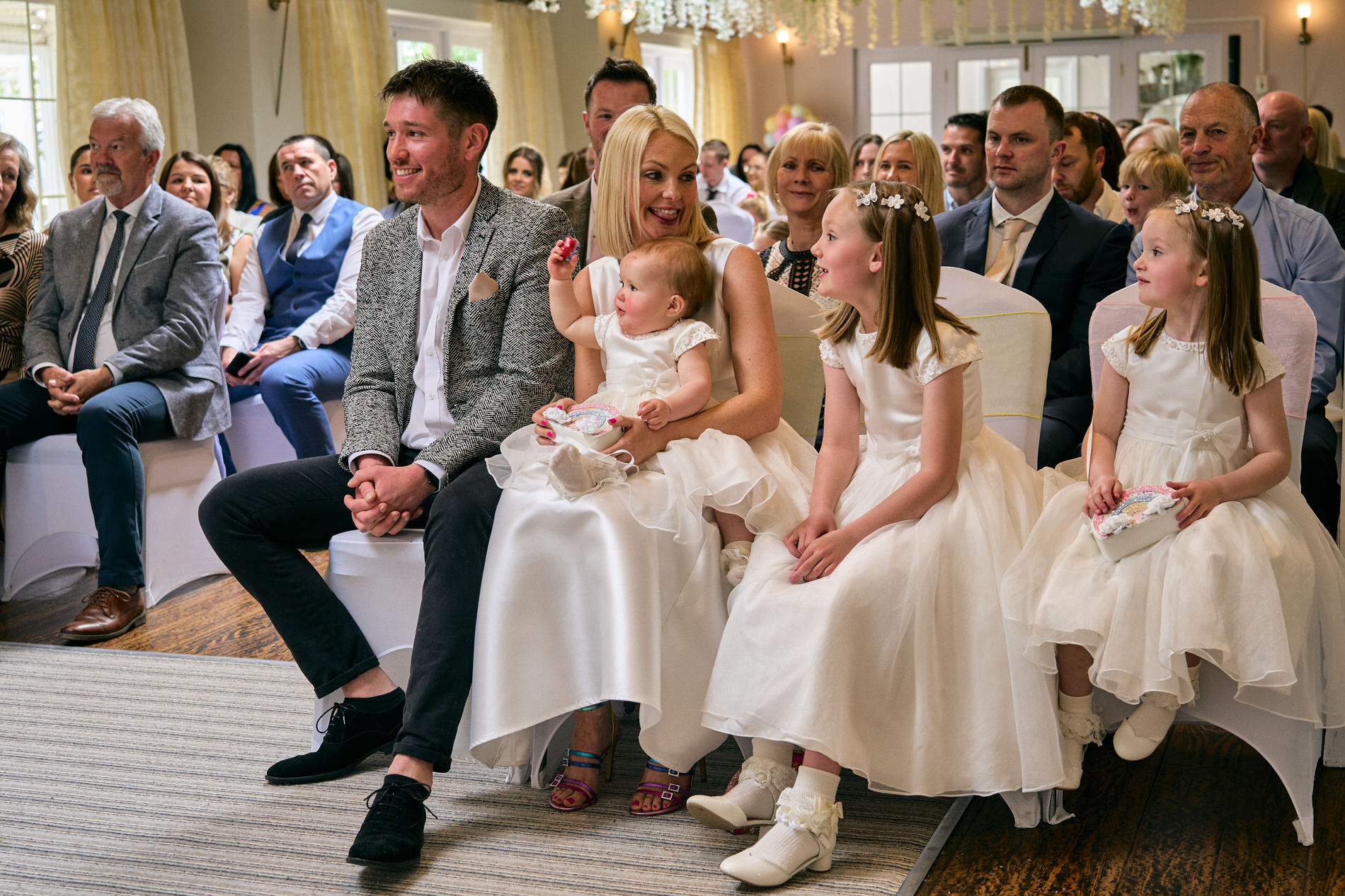 a colourful natural photo of a family smiling during a naming day ceremony in Lancashire
