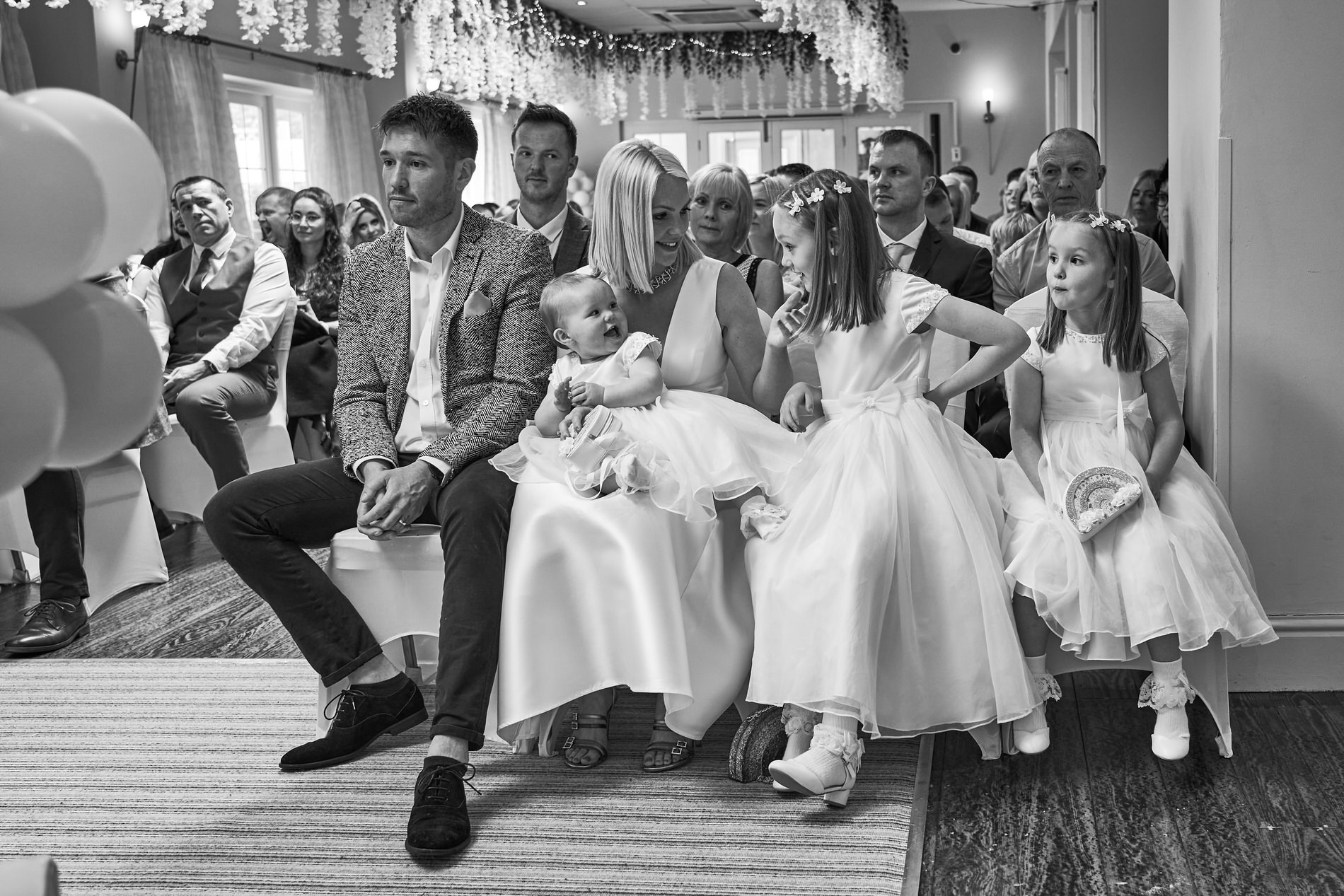a family sit front row for a personal naming day ceremony at Holland Hall