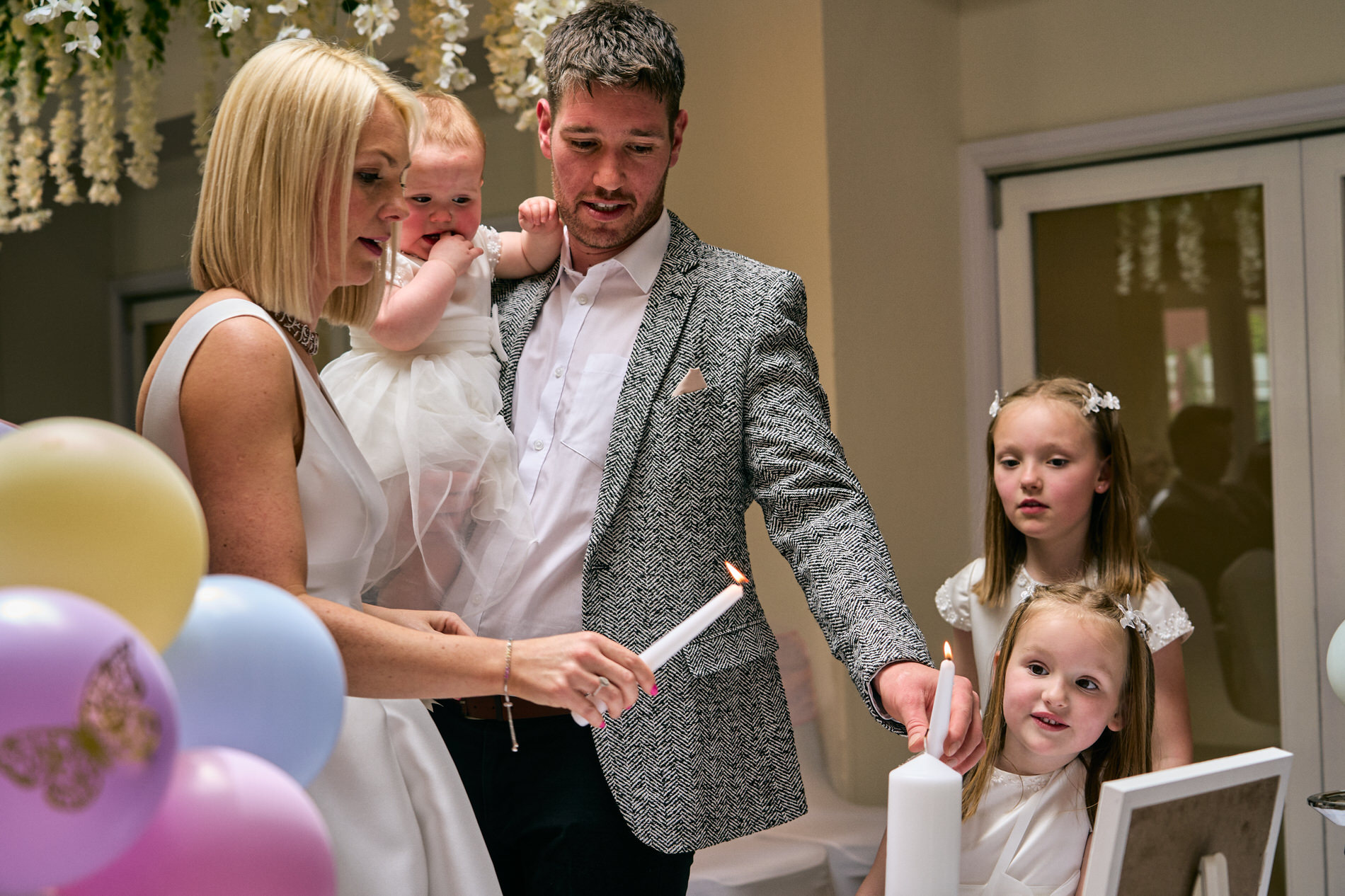 the family light a candle during a celebrant led naming day in Lancashire