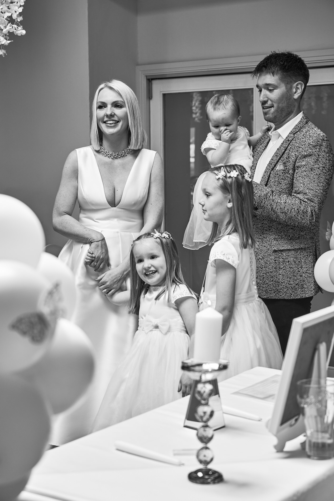 a family stand at the front of the naming day ceremony at Holland Hall