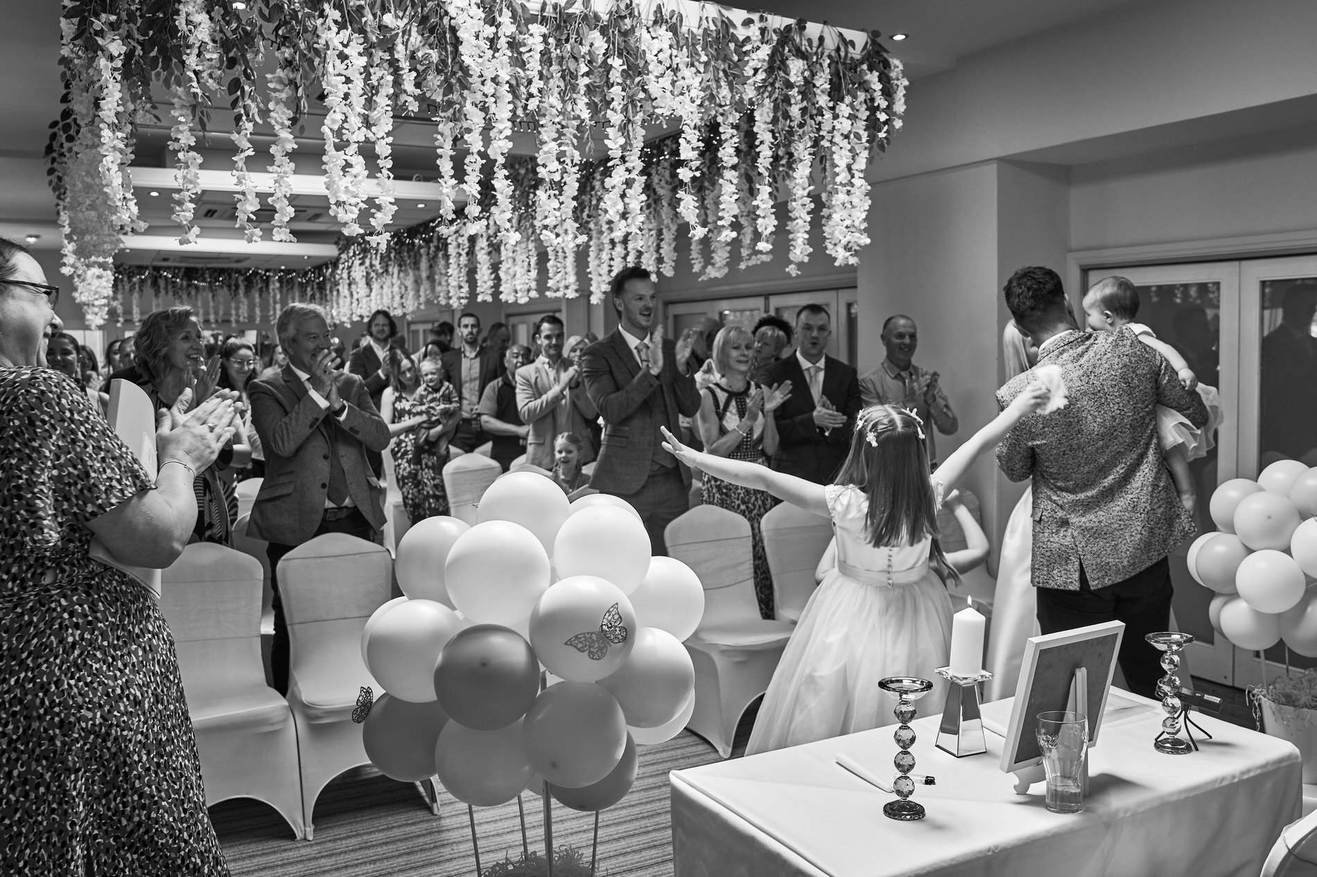 a photo of a girl twirling for the applause during naming day ceremony