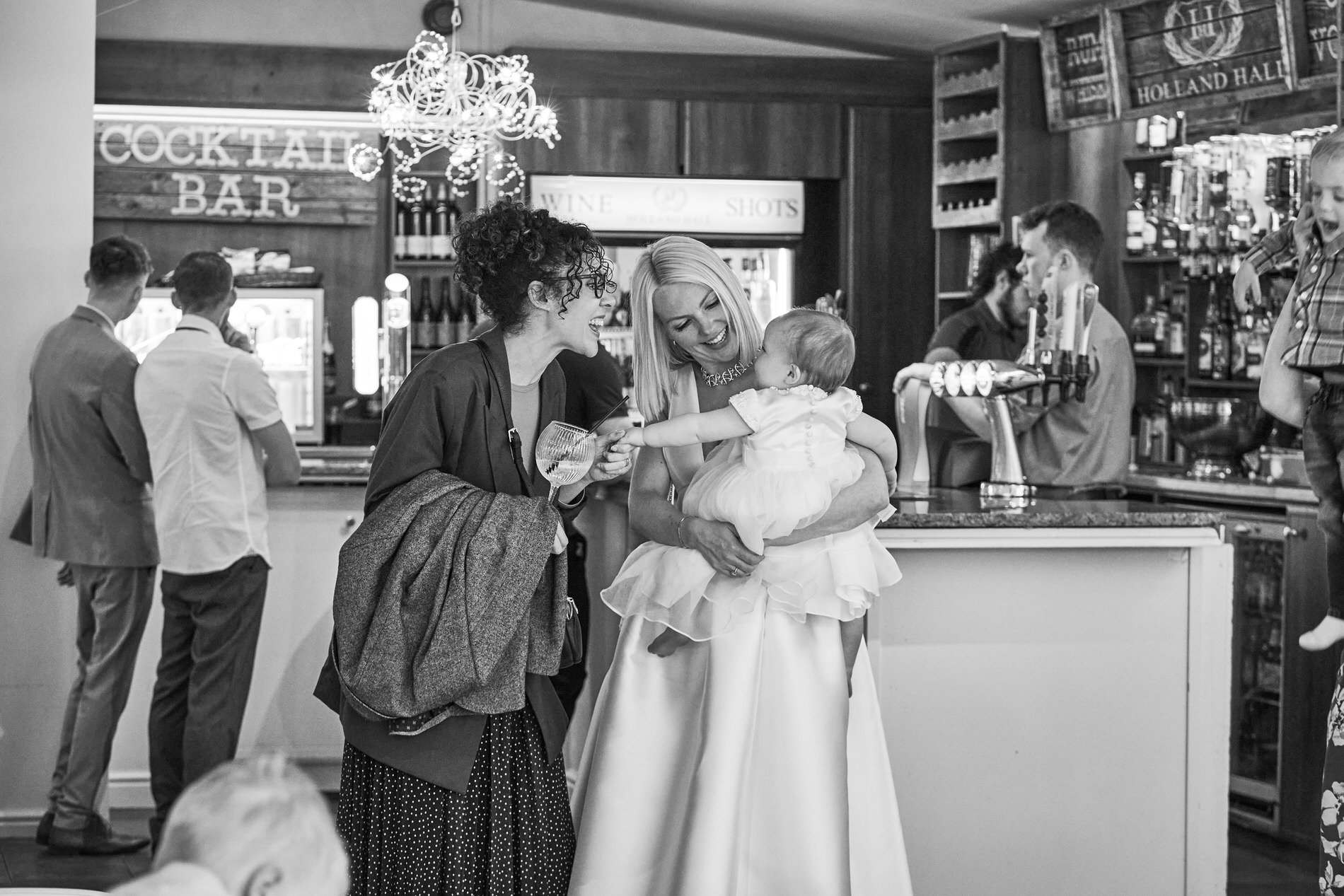 a natural photograph of friends fussing over the baby after her Naming Day