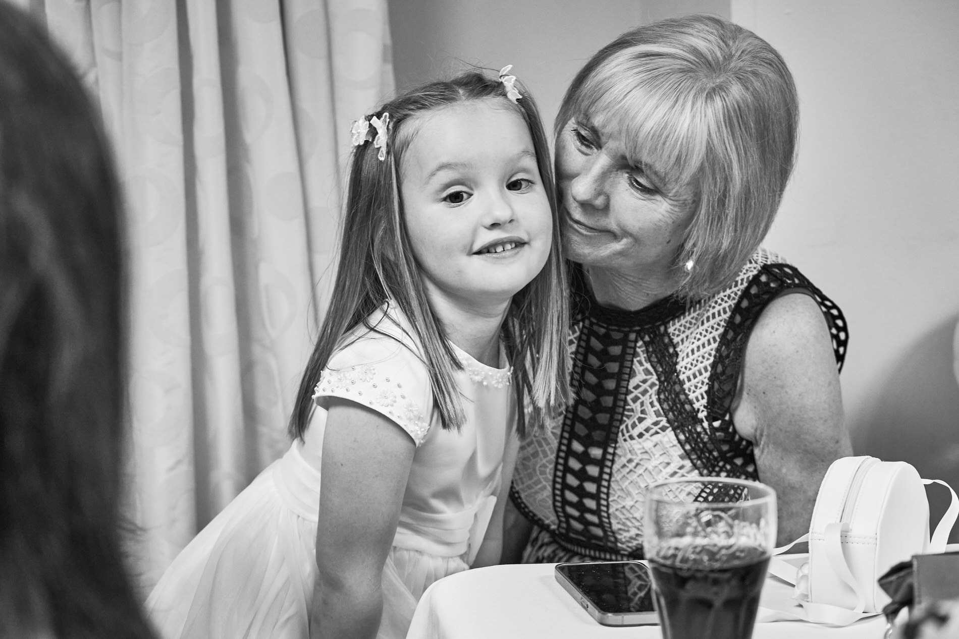 a grandparent cuddles in to her grandchild at Holland Hall