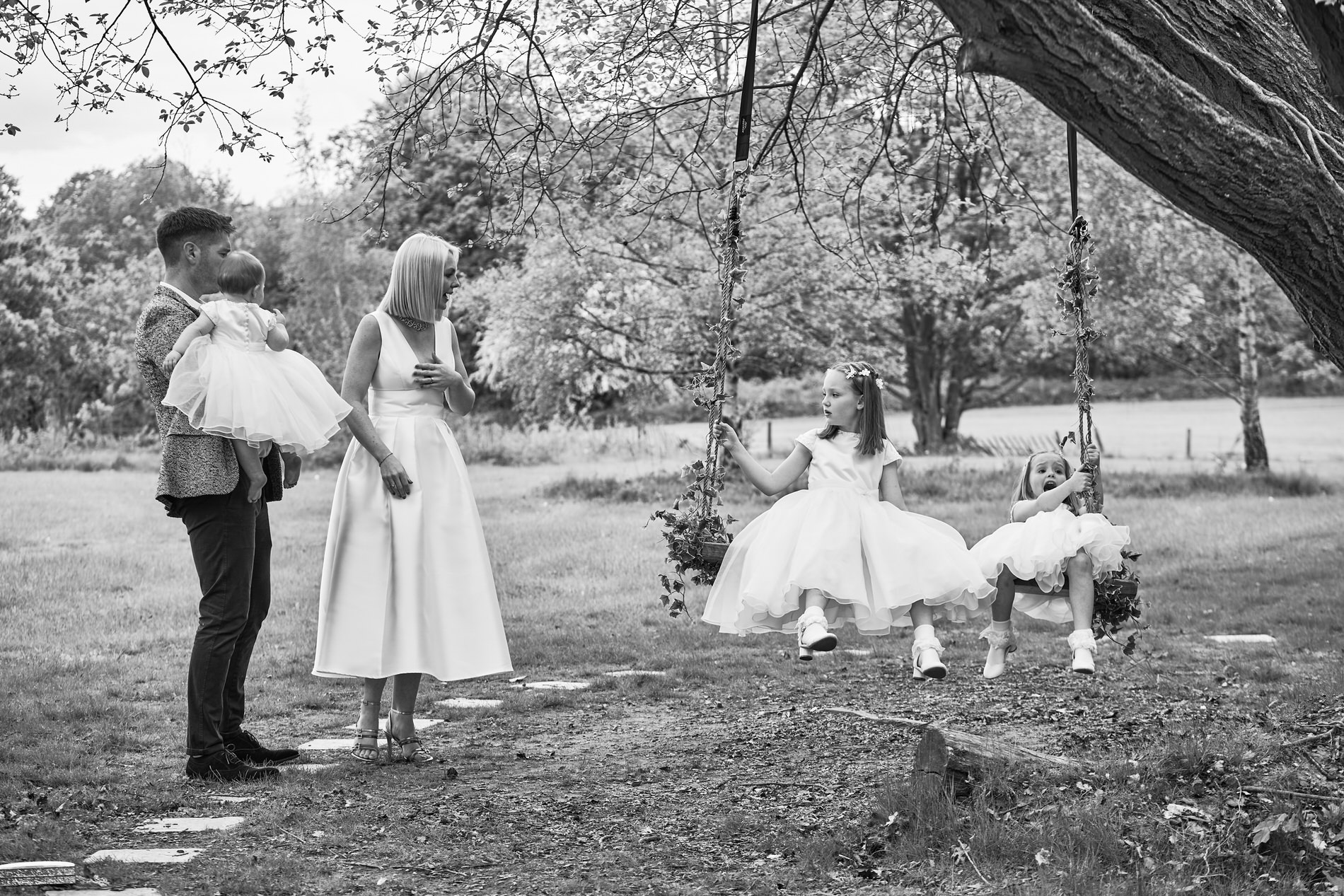 a family chat around the tree swing at Holland Hall for a candid unposed family photo