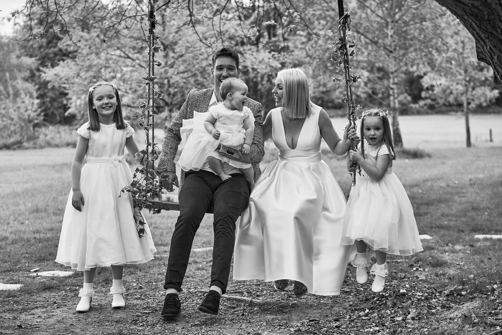 a black and white family portrait in the gardens of Holland Hall
