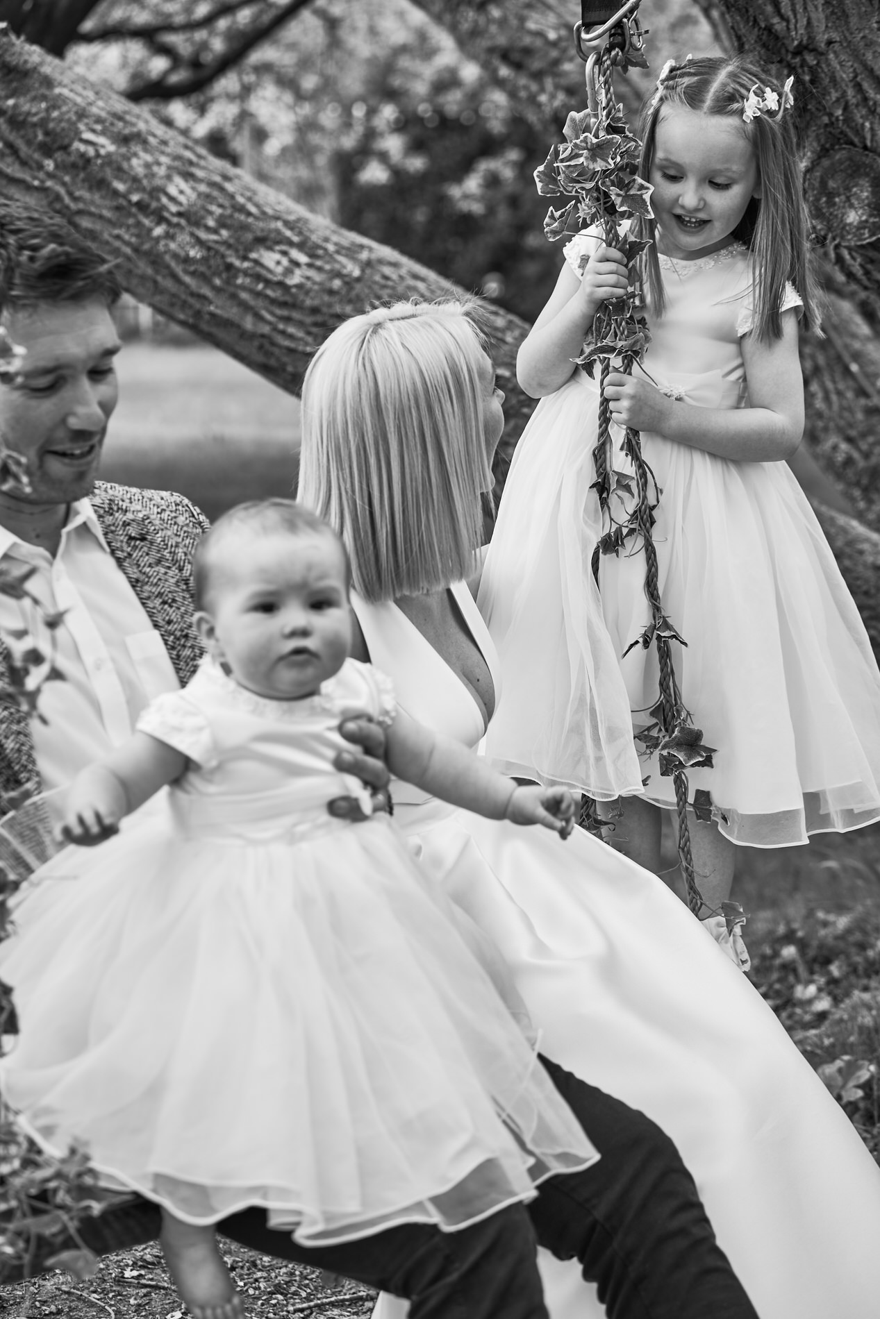 a candid relaxed photo of a family on the swing at holland hall during naming day