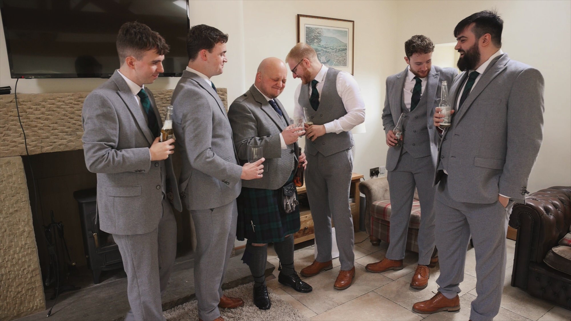 a groom pulls a face drinking strong scottish whisky