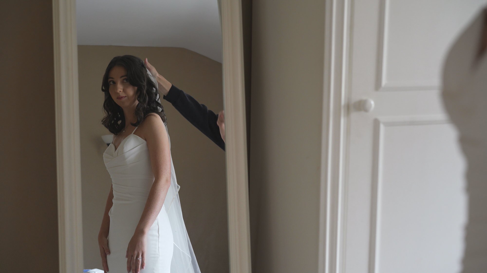 videographer films a bride glancing at her reflection at Browsholme Hall and Tithe Barn Lancashire