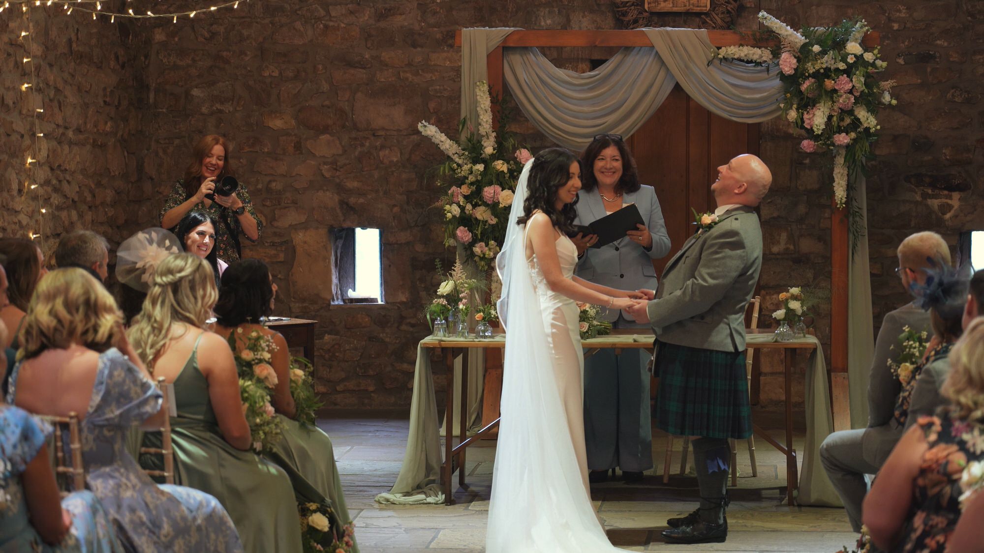 the couple laugh at each other during a ceremony at Browsholme Hall Lancashire