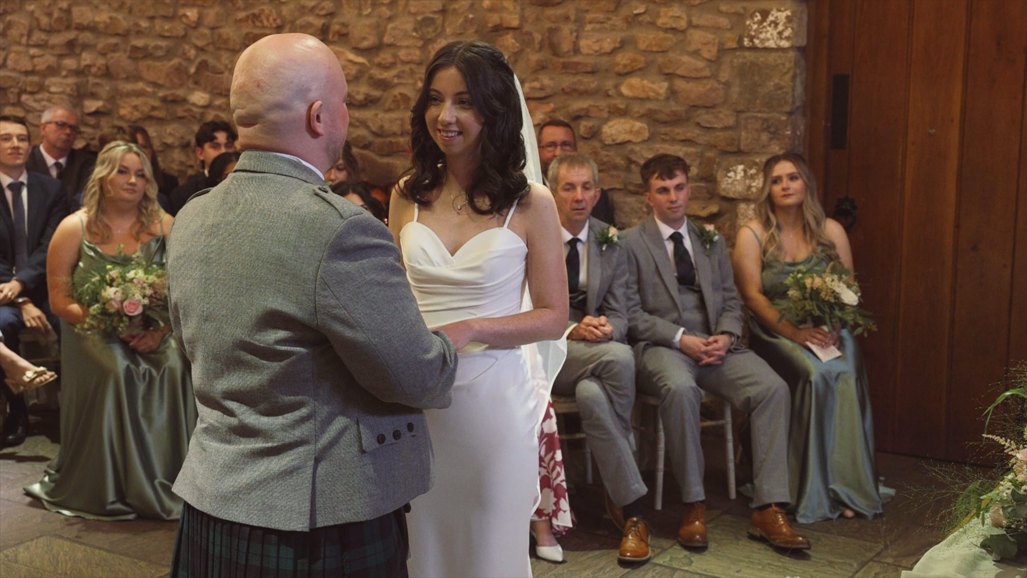 the bride and groom share personal vows during their wedding ceremony at Browsholme Hall