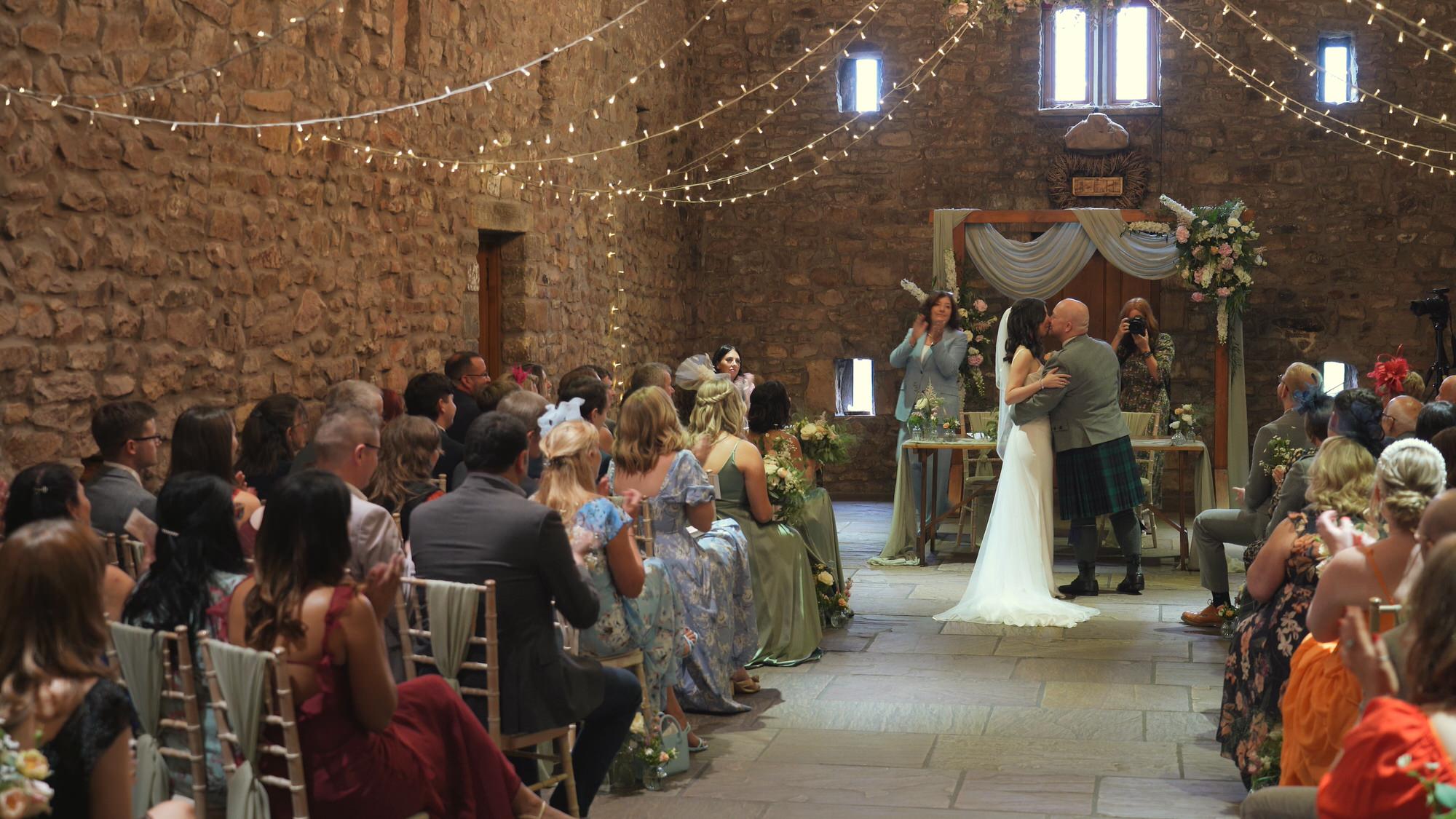a wide video still of a couples first kiss at Browsholme Hall Lancashire