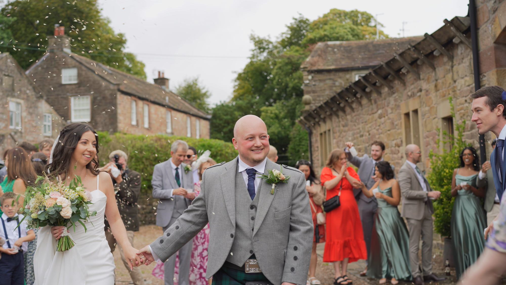a windy video moment of confetti being thrown outside Browsholme Hall Lancashire
