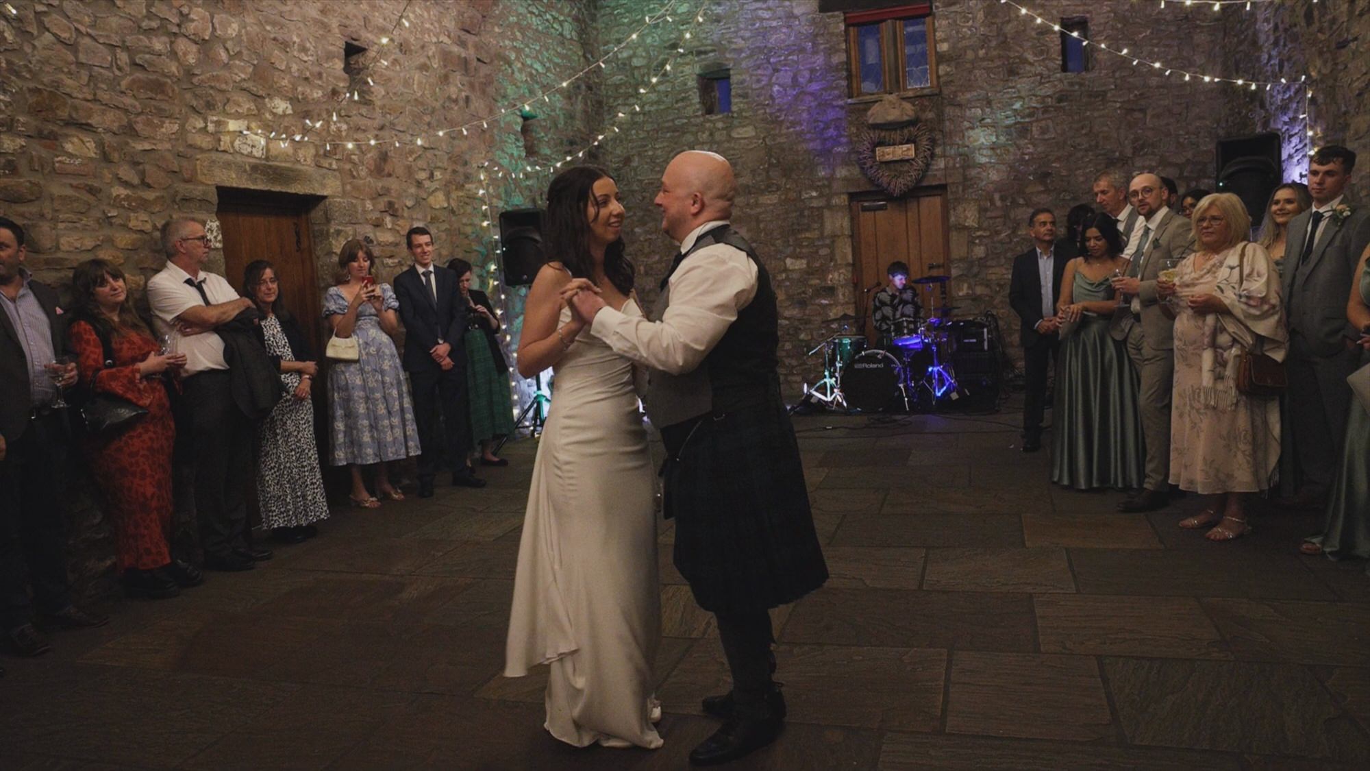 a couple smile as they enjoy their choreographed first dance at Browsholme Hall Lancashire