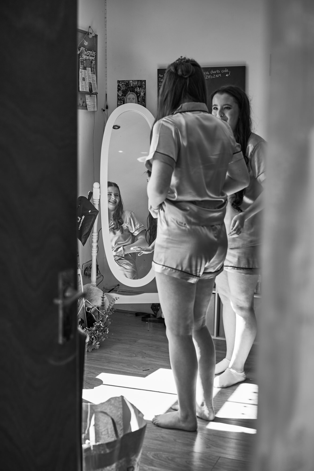 two bridesmaids plan tiktoks in their matching wedding pjs