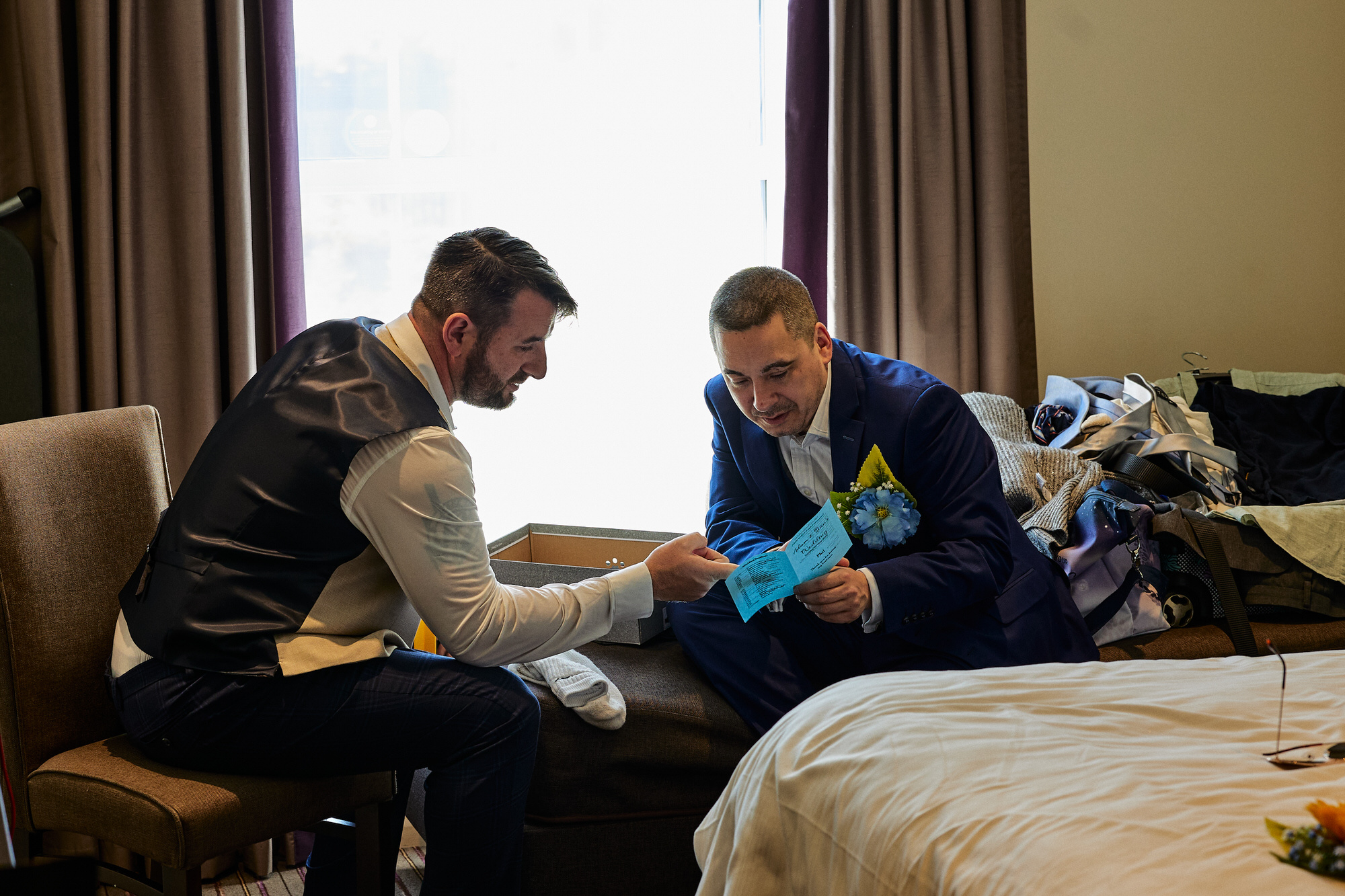 a groom goes over the wedding itinerary with his best man