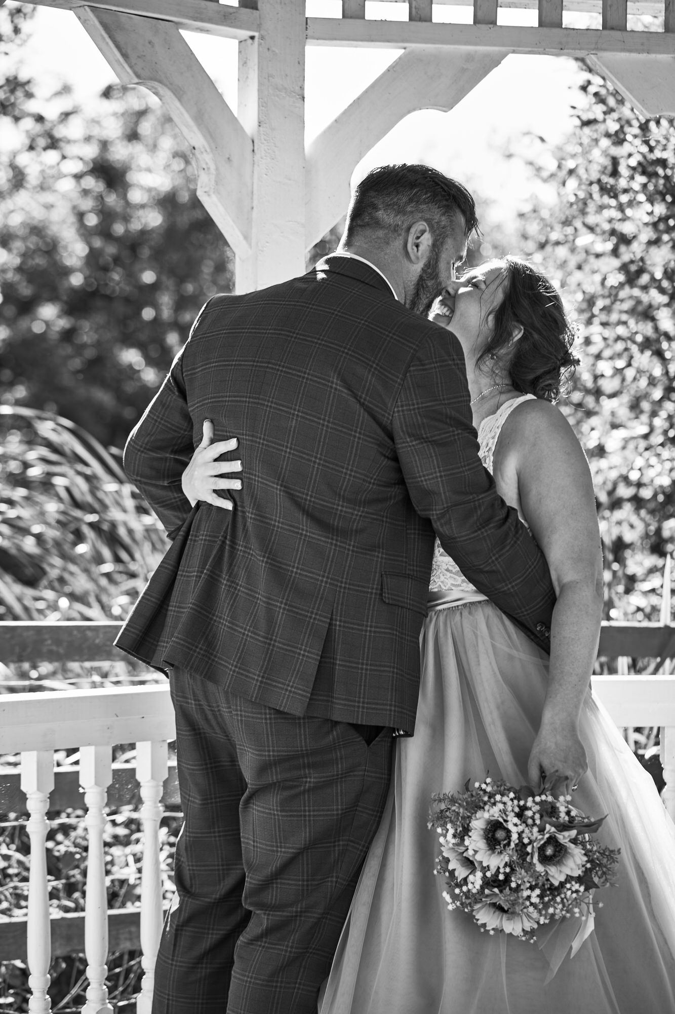 a bride and groom kiss for informal wedding portraits